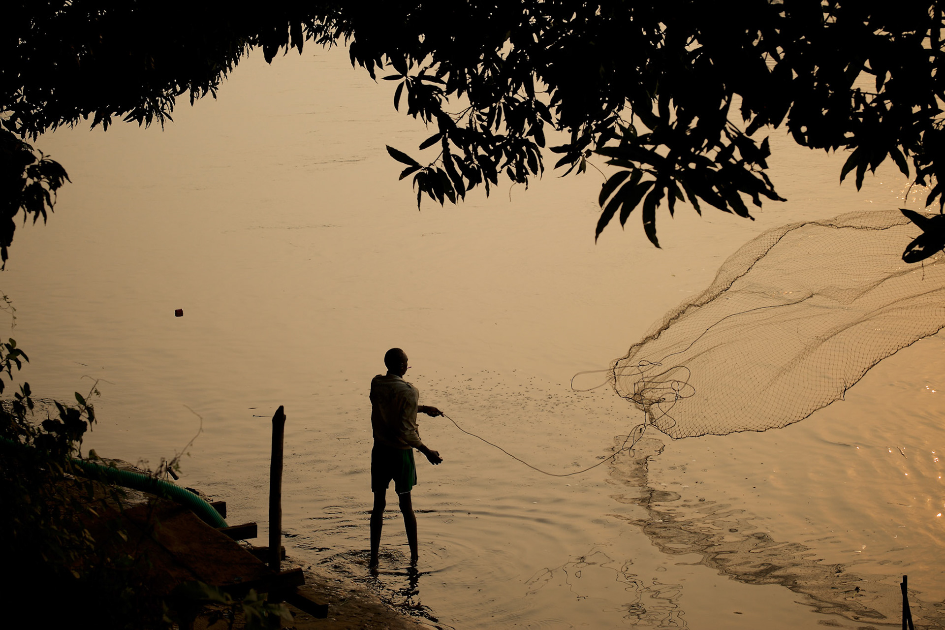 A local man casts the net during an early morning fishing session at the River Nile in Juba, South Sudan.