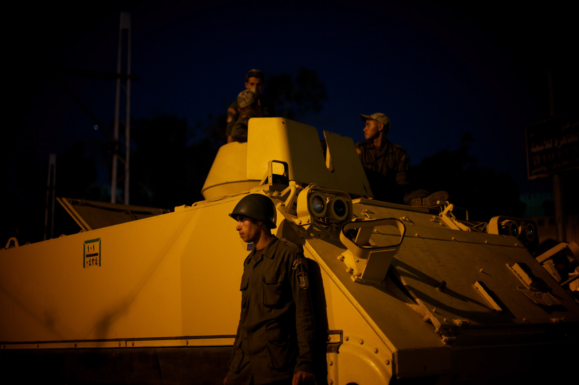 Egyptian Army men take guard at the presidential palace in Cairo where tens of thousands gathered to voice their anger against a planned referendum for a new islamic-based constitution planned by president Mohamed Morsi.