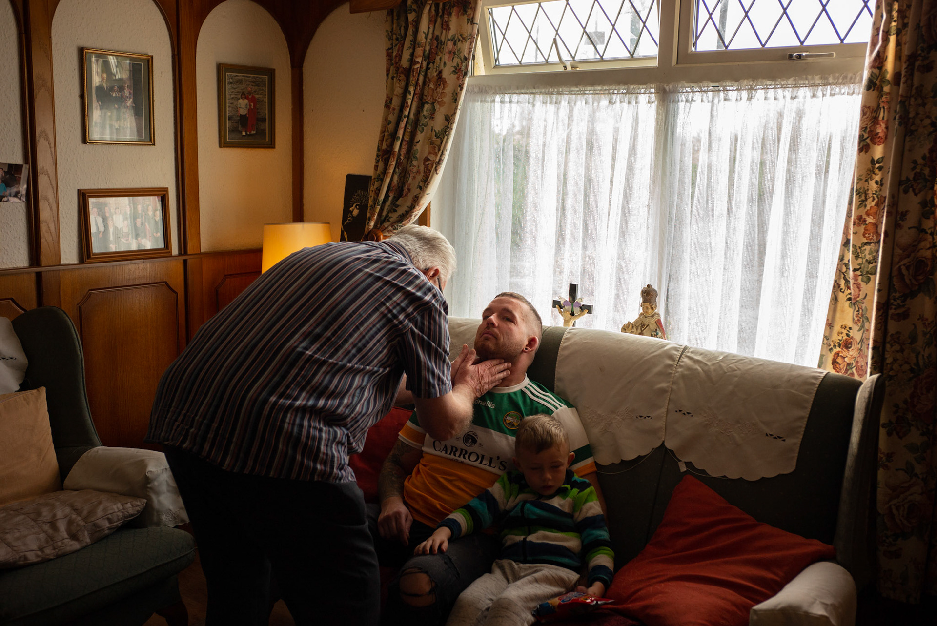 PULLOUGH, IRELAND - NOVEMBER 14, 2021: Faith Healer Joe Gallagher, performs the third and final session of ‘the cure’ for thrush on Joe Sweeney, a local man, at his house in Pullough, a small village in County Offaly, Ireland.With touch and prayers, every Sunday Joe gives ‘the cure’ to people looking for treatment for various ailments. As a seventh son, Joe, who is also a former monk, is known for having faith healing powers since young age. Faith healers have been around since antiquity and many Irish believe that certain people have God-given gifts to cure diseases. According to old Irish folklore, the seventh son of a seventh son has special healing powers, however, others get ‘the cure’ passed on to them by a parent or an older relative. CREDIT: Paulo Nunes dos Santos for The New York Times CREDIT: Paulo Nunes dos Santos for The New York Times