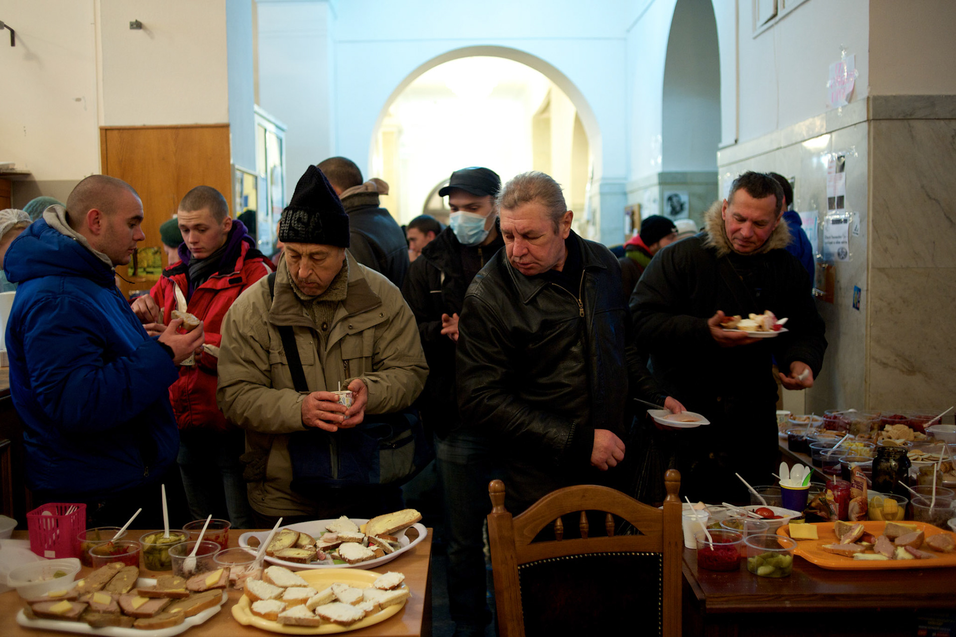 December 18, 2013 - Kiev, Ukraine: Pro-EU demonstrators get food donated inside the occupied City Hall.On the night of 21 November 2013, a wave of demonstrations and civil unrest began in Ukraine, when spontaneous protests erupted in the capital of Kiev as a response to the government’s suspension of the preparations for signing an association and free trade agreement with the European Union. Anti-government protesters occupied Independence Square, also known as Maidan, demanding the resignation of President Viktor Yanukovych and accusing him of refusing the planned trade and political pact with the EU in favor of closer ties with Russia.After a days of demonstrations, an increasing number of people joined the protests. As a responses to a police crackdown on November 30, half a million people took the square. The protests are ongoing despite a heavy police presence in the city, regular sub-zero temperatures, and snow. (Paulo Nunes dos Santos)