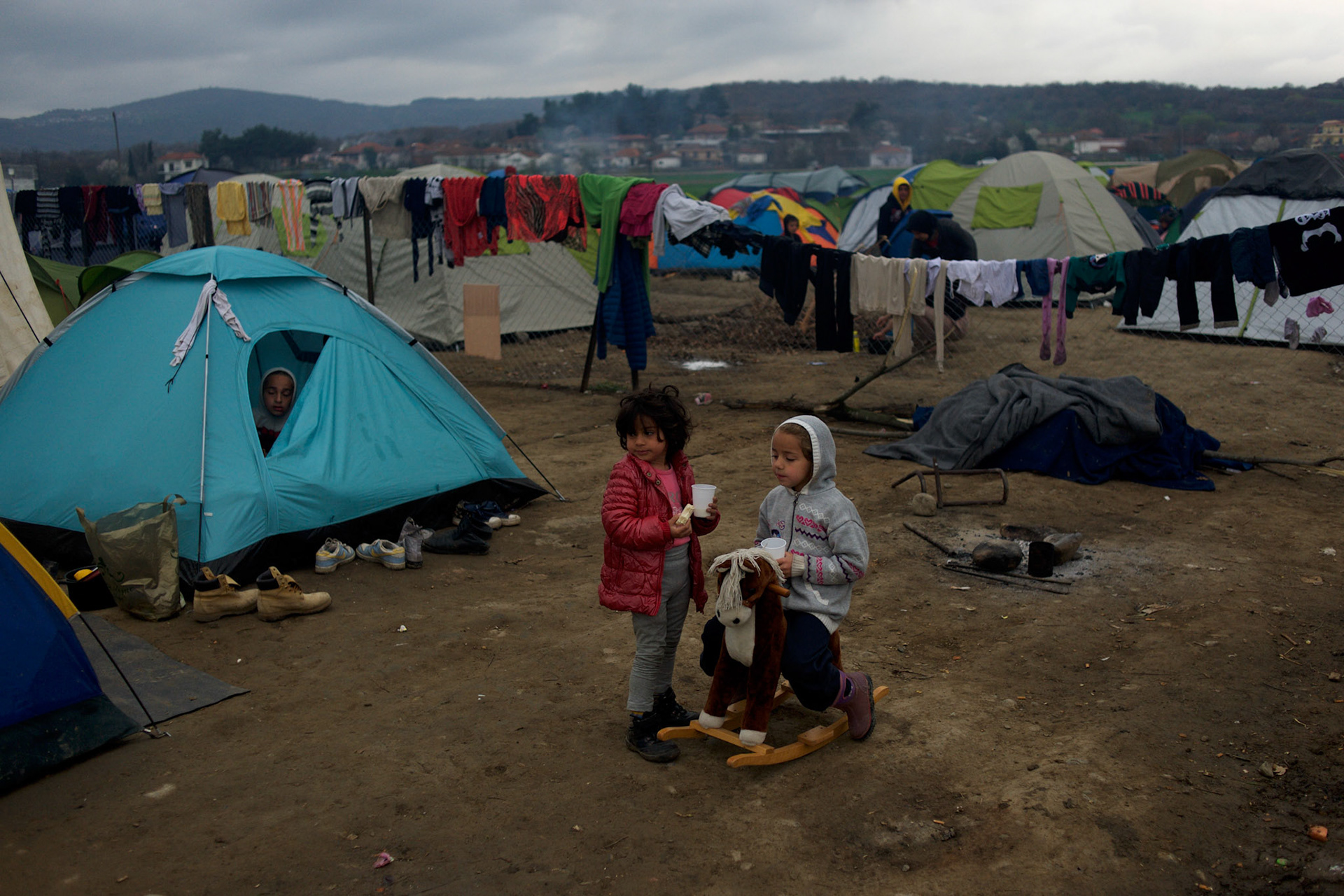 Syrian children play outside a tent at the Greek-Macedonian border station of Idomeni, Greece. Around 13,000 migrants and refugees, mostly from the Middle East and African nations, are believe to be stranded here awaiting a chance to proceed their journey towards Germany and other northern European countries.