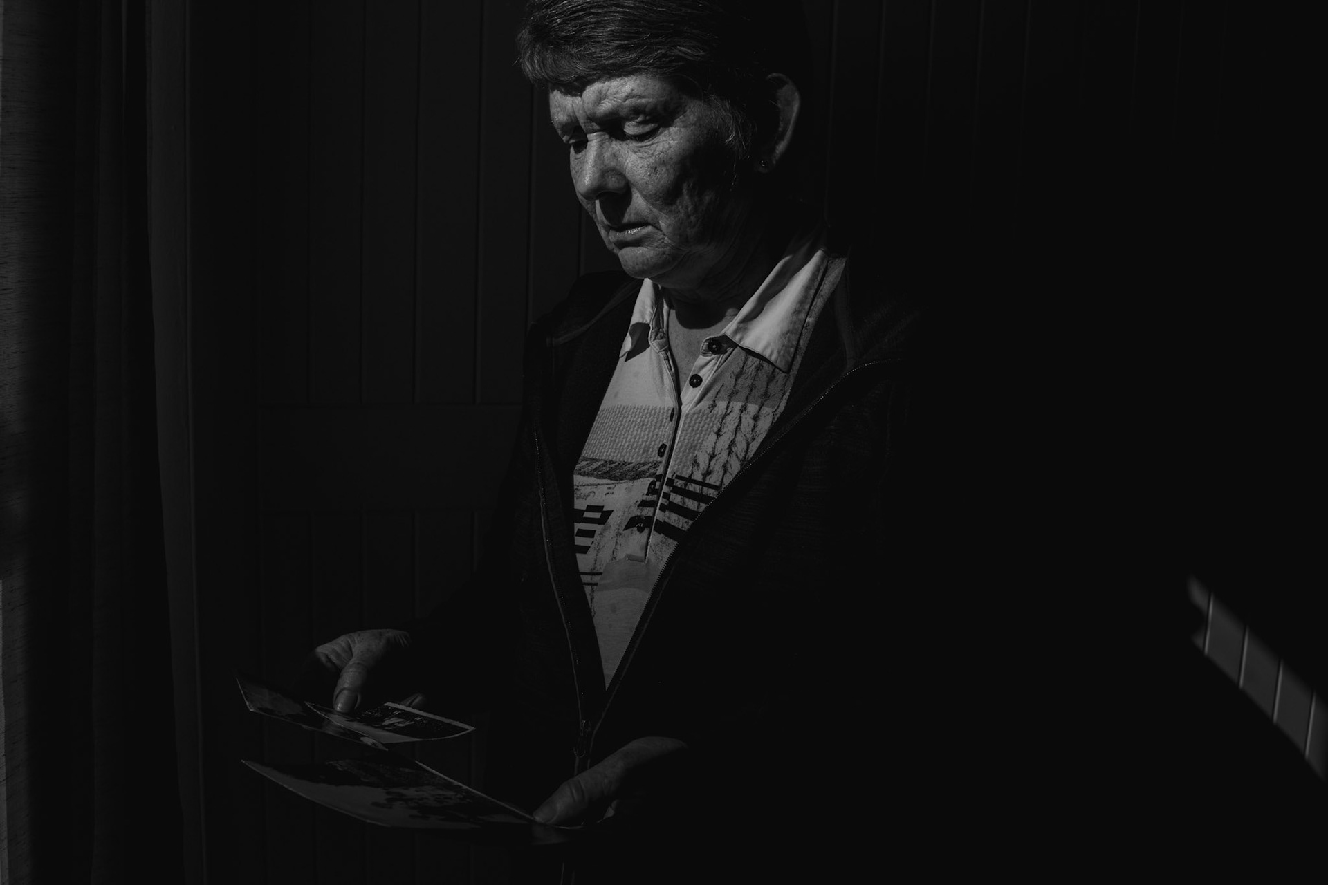 TUAM, IRELAND - SEPTEMBER 21, 2017: Local historian Catherine Corless contemplates childhood photographs in her house in the outskirts of Tuam, Ireland. Corless's investigation into a burial site in St. Mary’s Mother and Baby Home in Tuam, where she believed 796 children, most of them infants, were interred between 1925 and 196, proved to be right when a state-financed investigation uncovered the remains of babies, small children and foetuses interred where she said they would. CREDIT: Paulo Nunes dos Santos for The New York Times