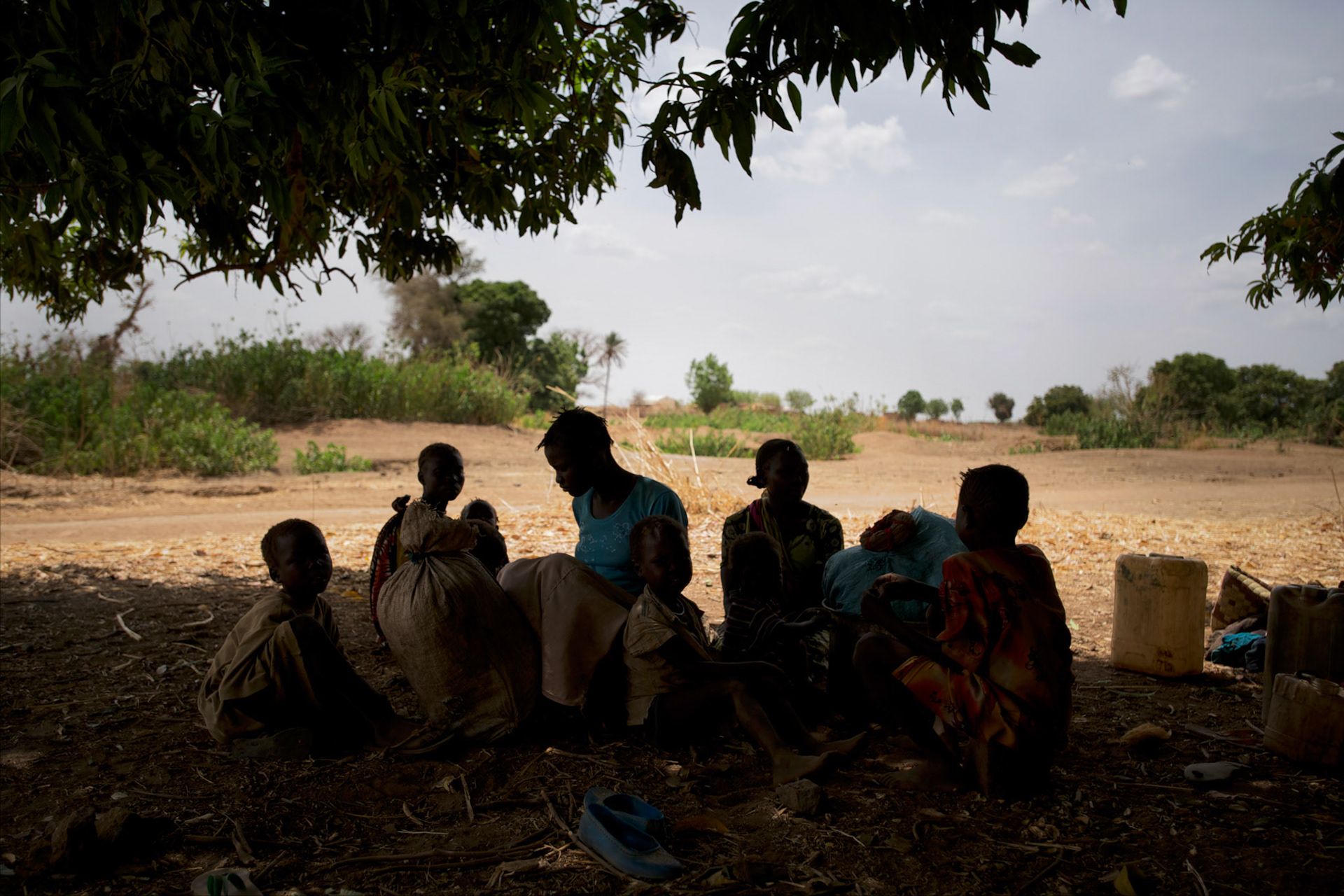 A Nuba family rests under the shade of a tree before continue the three to four day journey to a refugee camp in the neighbour South Sudan. Thousands of people have fled the war and hunger in South Kordofan.
