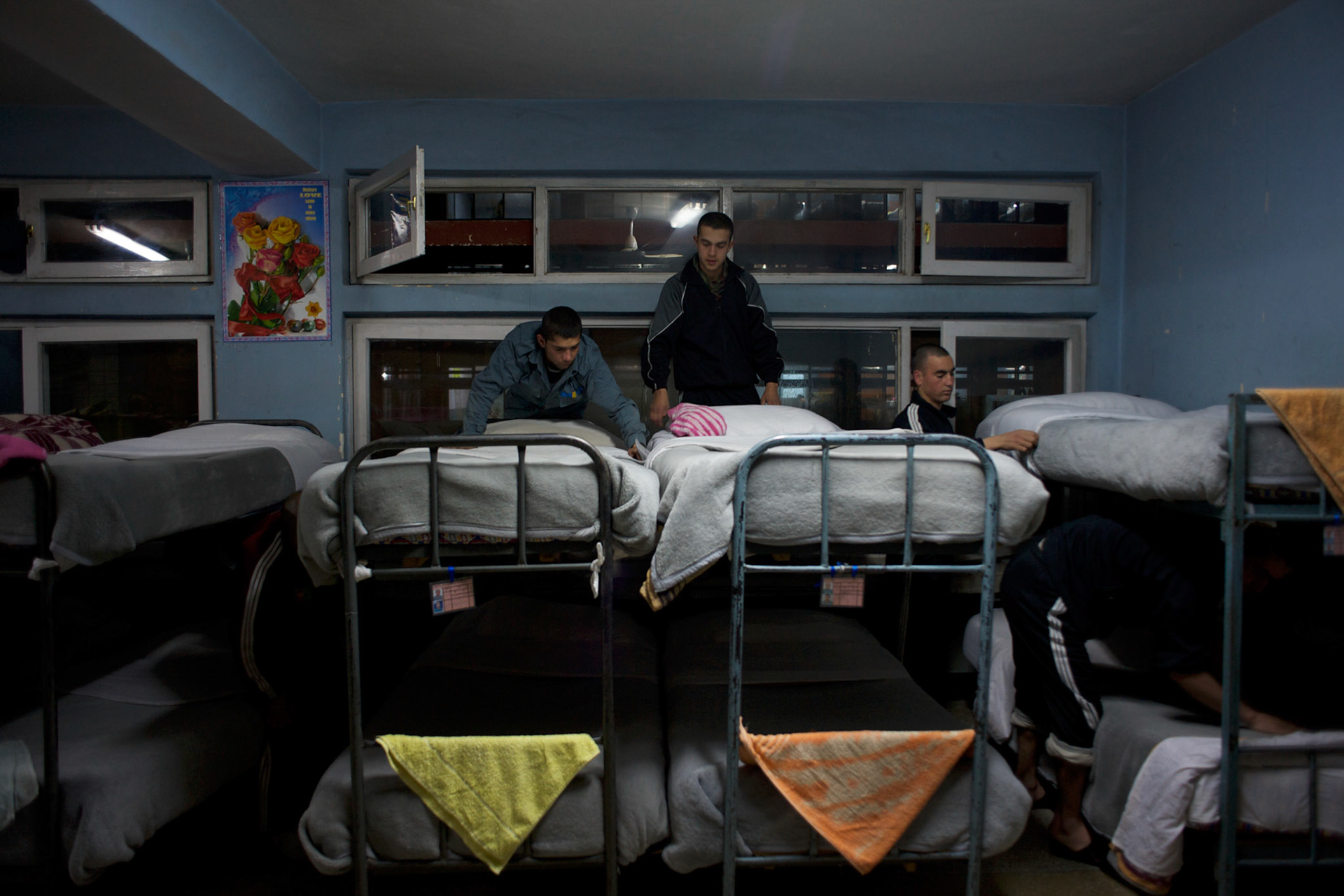 Afghan National Police (ANP) cadets tide their beds in the early hours of the morning at the Afghan Nacional Police Academy in Kabul.