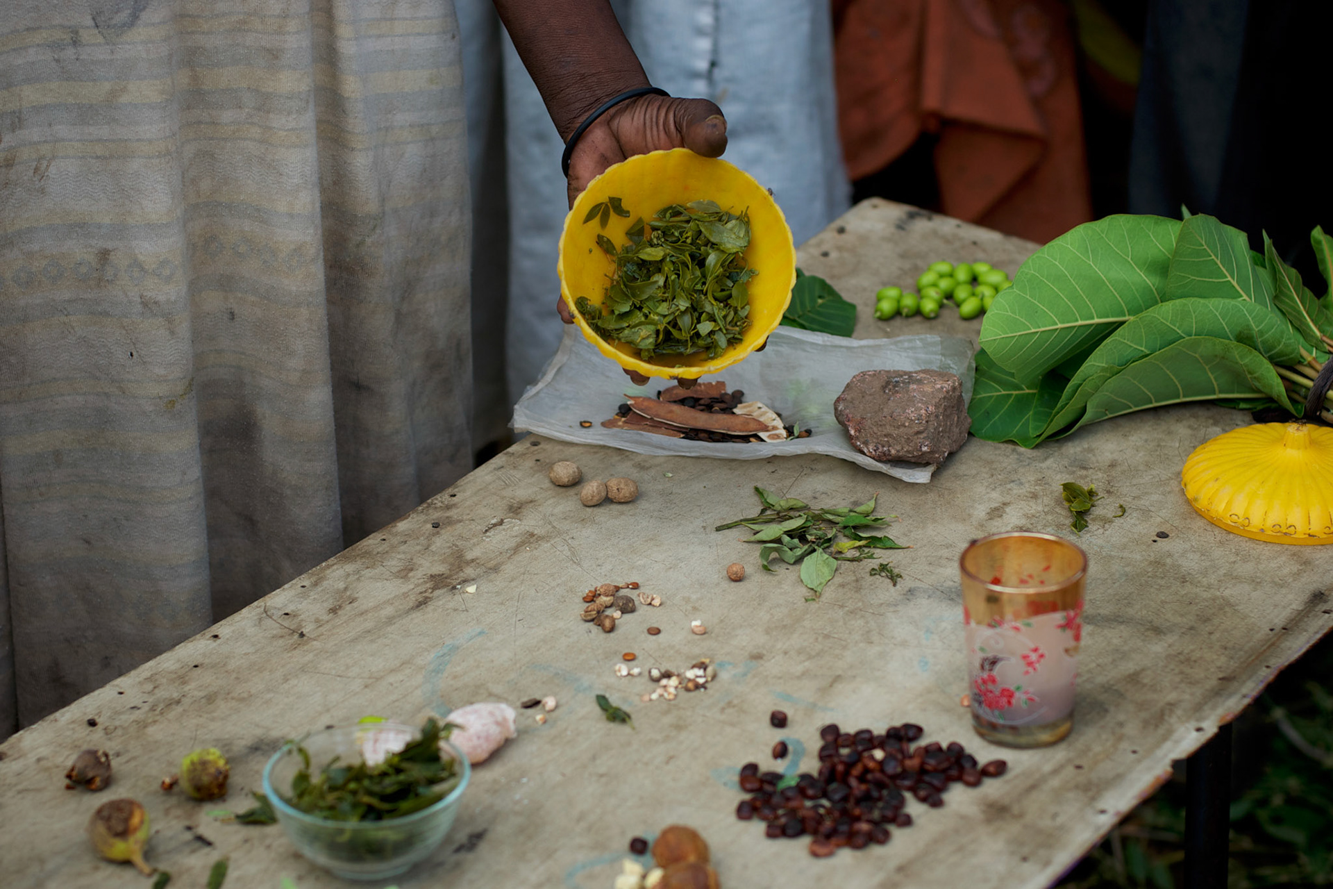 A local resident shows the food available for the whole family at their improvised home in the caves outside Buram village in South Kordofan's Nuba Mountains.