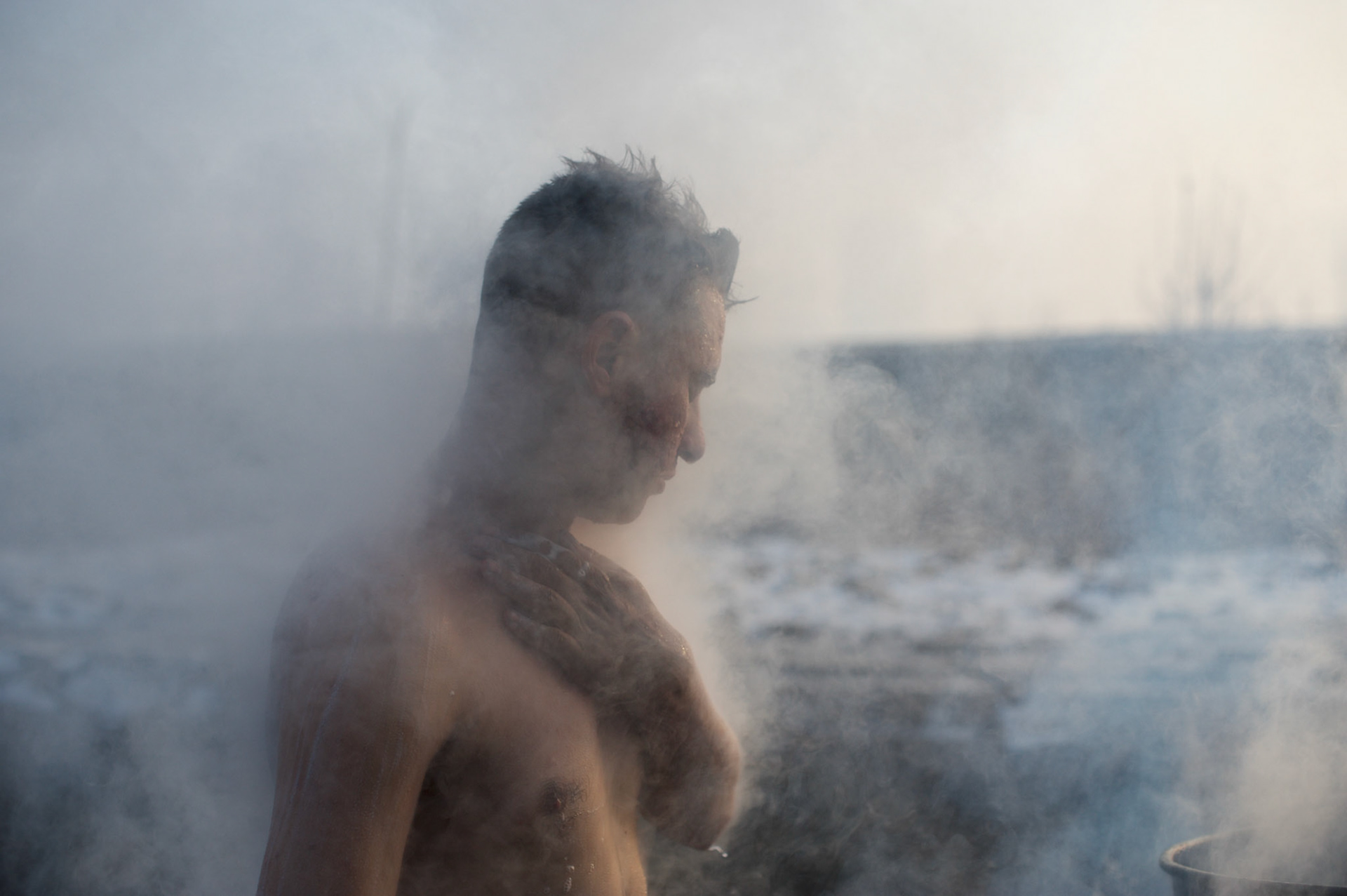 An afghani migrant washes himself with water heated on an open fire outside a warehouse near Belgrade’s main railway station. Some days the temperatures here drop to -15 degrees Celsius.