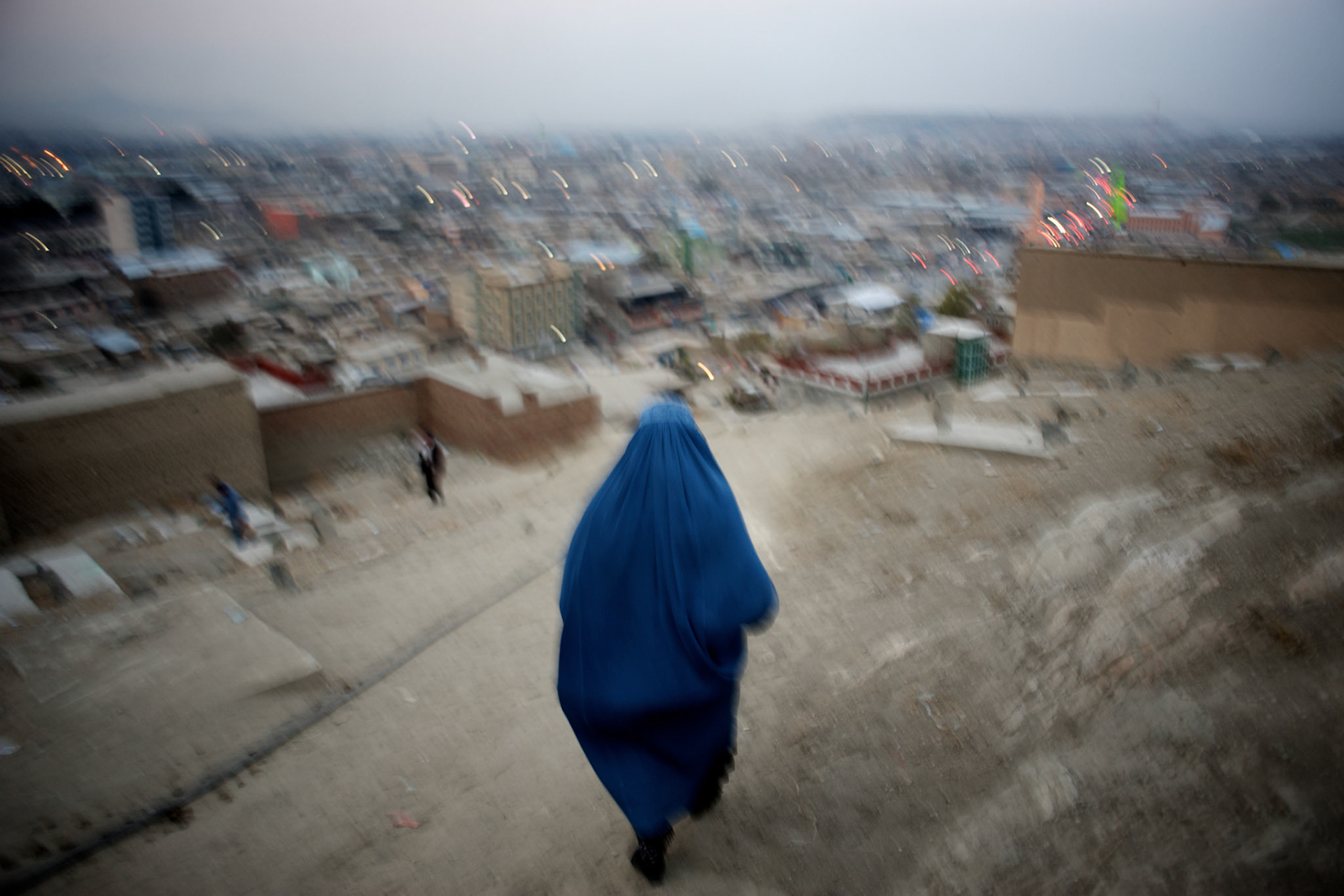 November 17, 2012 - Kabul, Afghanistan: A woman  wearing a burka walks down a hilltop neighbourhood in Kabul. (Paulo Nunes dos Santos)