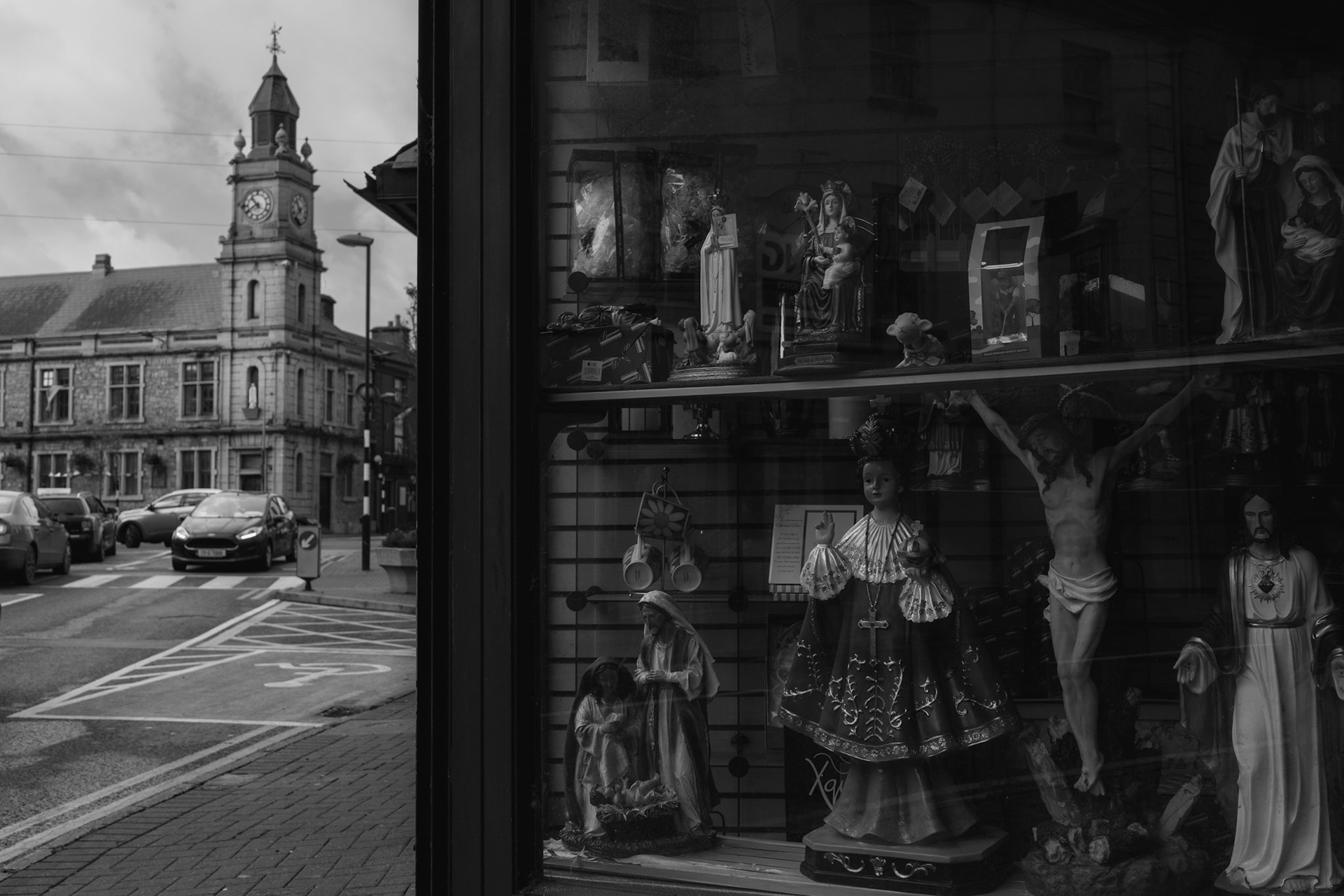 TUAM, IRELAND - OCTOBER 26, 2022: Religious icons can be seen on display for sale at a local shop in central Tuam, Ireland, on October 26, 2022. In 2014, local historian, Catherine Corless, went public with information concerning the deaths of 798 children at St. Mary’s Mother and Baby Home, a maternity home for unmarried mothers and their children run by the Bon Secours order in Tuam. Corless' research led her to conclude that almost all had been buried in an unmarked and unregistered site at the Home. Subsequent excavations carried out by an Irish government appointed Commission, found a significant quantity of human remains in a vault with twenty chambers, believed to be part of an old septic tank from the period the site was use as a workhouse. CREDIT: Paulo Nunes dos Santos for The New York Times
