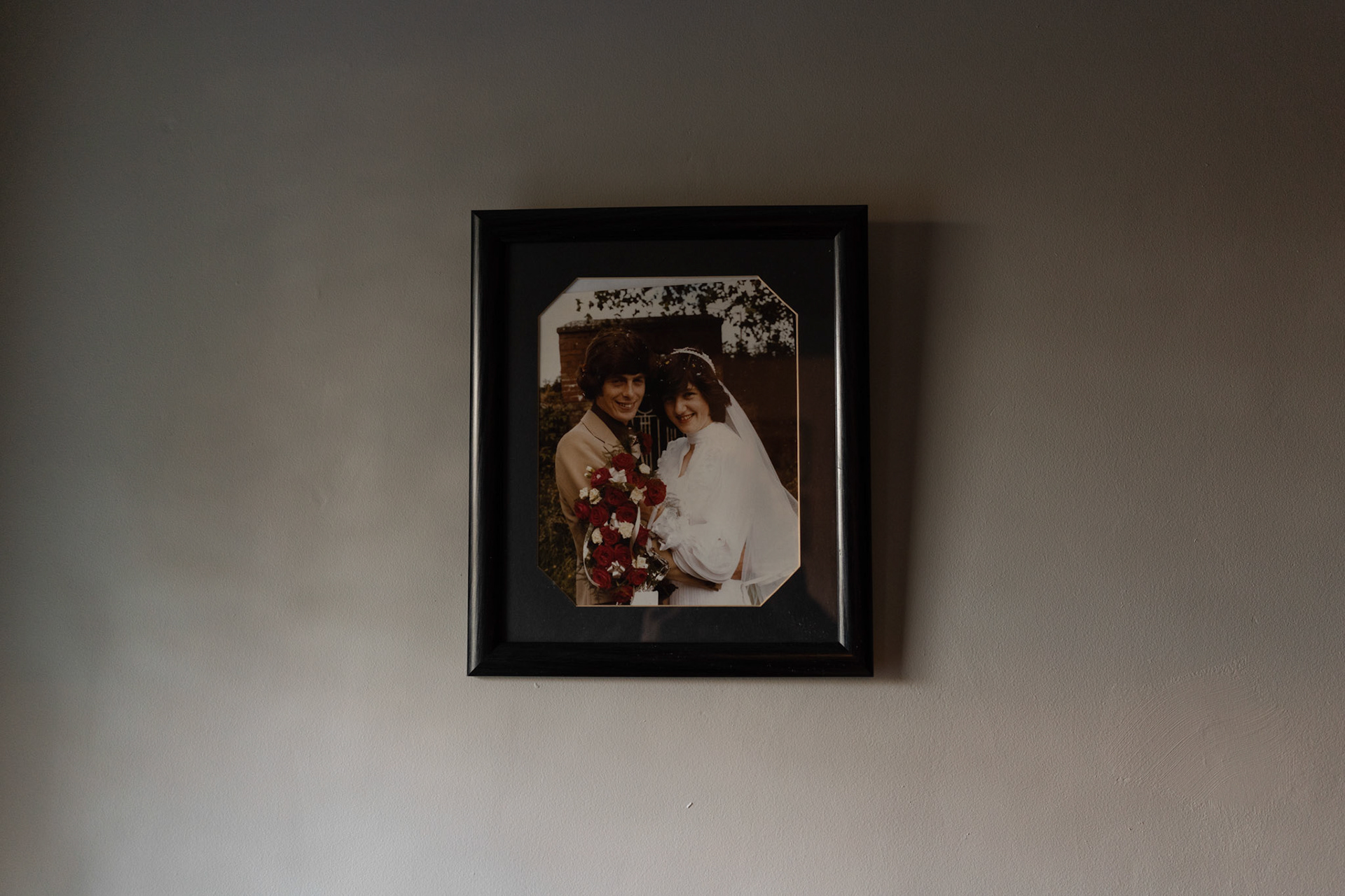 GEASHILL, IRELAND - NOVEMBER 10, 2021: A weeding photograph of Peter and Patricia Quinn, a couple with traditional faith healing powers, can be seen hanging at the entrance hall of their farmhouse house in Geashill, a small village in County Offaly, Ireland, on November 10, 2021. Faith healers have been around since antiquity and many Irish believe that certain people have God-given gifts to cure ailments. According to old Irish folklore, the seventh son of a seventh son has special healing powers, however, others, like the Quinns, get the “Cure” passed on to them by a parent or an older relative. CREDIT: Paulo Nunes dos Santos for The New York Times