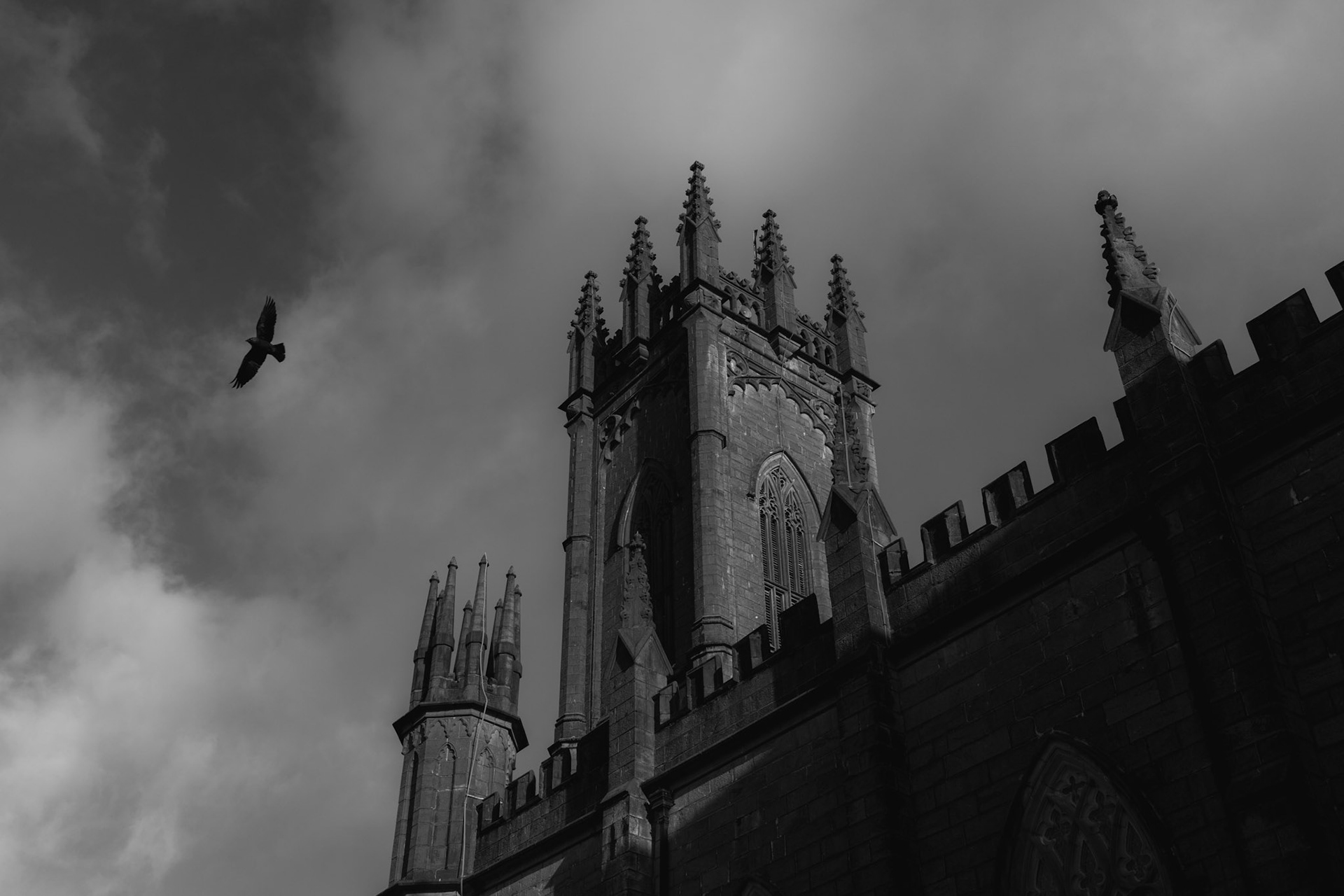 TUAM, IRELAND - OCTOBER 26, 2022: A bird flies by the Cathedral of the Assumption of the Blessed Virgin Mary in central Tuam, Ireland, on October 26, 2022. In 2014, local historian, Catherine Corless, went public with information concerning the deaths of 798 children at St. Mary’s Mother and Baby Home, a maternity home for unmarried mothers and their children run by the Bon Secours order in Tuam. Corless' research led her to conclude that almost all had been buried in an unmarked and unregistered site at the Home. Subsequent excavations carried out by an Irish government appointed Commission, found a significant quantity of human remains in a vault with twenty chambers, believed to be part of an old septic tank from the period the site was use as a workhouse. CREDIT: Paulo Nunes dos Santos for The New York Times