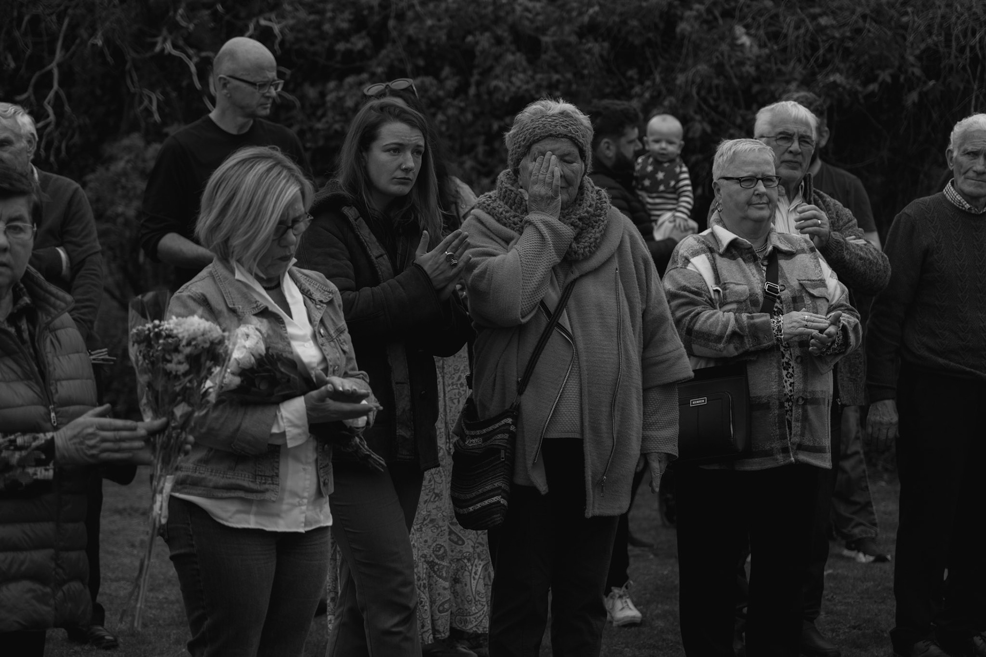 TUAM, IRELAND - OCTOBER 02, 2022: People attending a ceremony honouring hundreds of infant bodies buried on the grounds of the former St. Mary’s Mother and Baby Home in Tuam, Ireland, on October 02, 2022. In 2014, local historian, Catherine Corless, went public with information concerning the deaths of 798 children at St. Mary’s Mother and Baby Home, a maternity home for unmarried mothers and their children run by the Bon Secours order in Tuam. Corless' research led her to conclude that almost all had been buried in an unmarked and unregistered site at the Home. Subsequent excavations carried out by an Irish government appointed Commission, found a significant quantity of human remains in a vault with twenty chambers, believed to be part of an old septic tank from the period the site was use as a workhouse. CREDIT: Paulo Nunes dos Santos for The New York Times