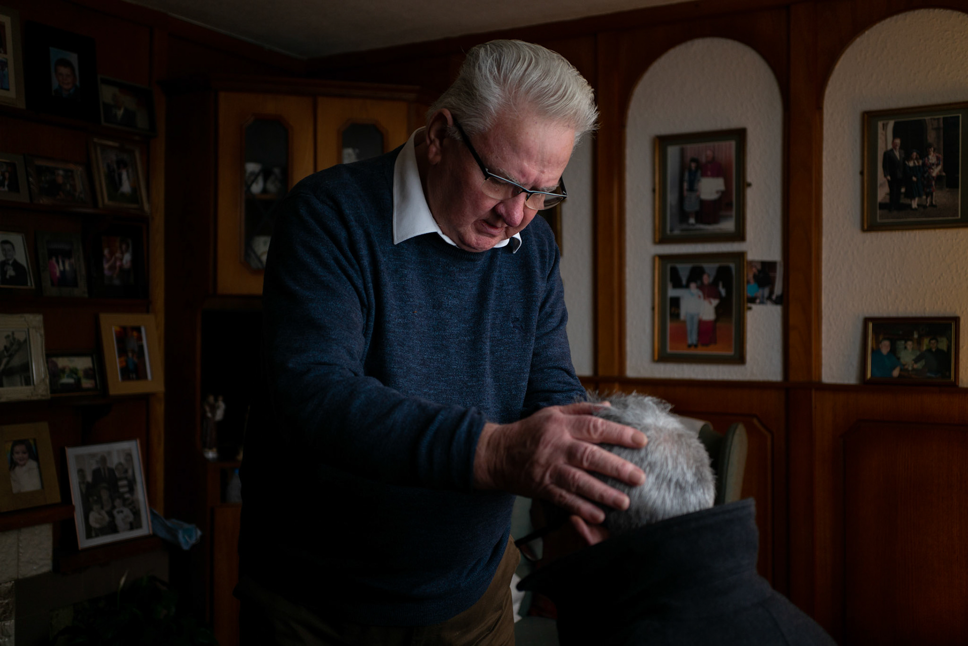 PULLOUGH, IRELAND - NOVEMBER 28, 2021: Faith Healer Joe Gallagher, performs ‘the cure’ on David Hickey, a local farmer with ring worm, at his house in Pullough, a small village in County Offaly, Ireland.With touch and prayers, every Sunday Joe gives ‘the cure’ to people looking for treatment for various ailments. As a seventh son, Joe, who is also a former monk, is known for having faith healing powers since young age.Faith healers have been around since antiquity and many Irish believe that certain people have God-given gifts to cure diseases. According to old Irish folklore, the seventh son of a seventh son has special healing powers, however, others get ‘the cure’ passed on to them by a parent or an older relative. CREDIT: Paulo Nunes dos Santos for The New York Times