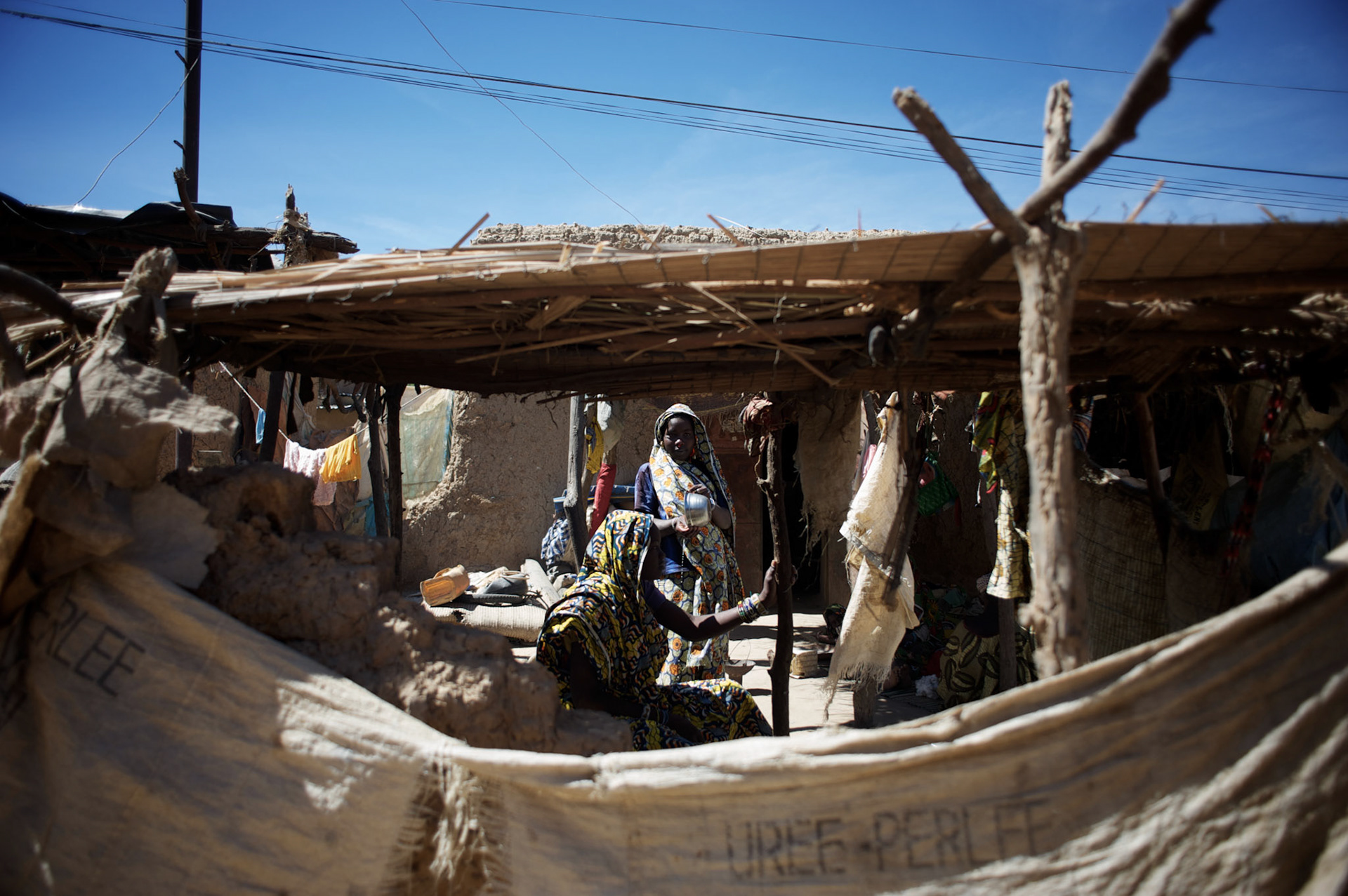 January 21, 2013 - Diabaly, Mali: Local merchants at a stall in Diabaly market, a day after Mali government troops regain control of the city. Diabaly was under islamist militants control since the 14th of January.Several insurgent groups have been fighting a campaign against the Malian government for independence or greater autonomy for northern Mali, an area known as Azawad. The National Movement for the Liberation of Azawad (MNLA), an organisation fighting to make Azawad an independent homeland for the Tuareg people, had taken control of the region by April 2012.The Malian government pledge to the French army to help the national troops to stop the rebellion advance towards the capital Bamako. The french troops started aerial attacks on rebel positions in the centre of the country and deployed several hundred special forces men to counter attack the advance on the ground. (Paulo Nunes dos Santos)