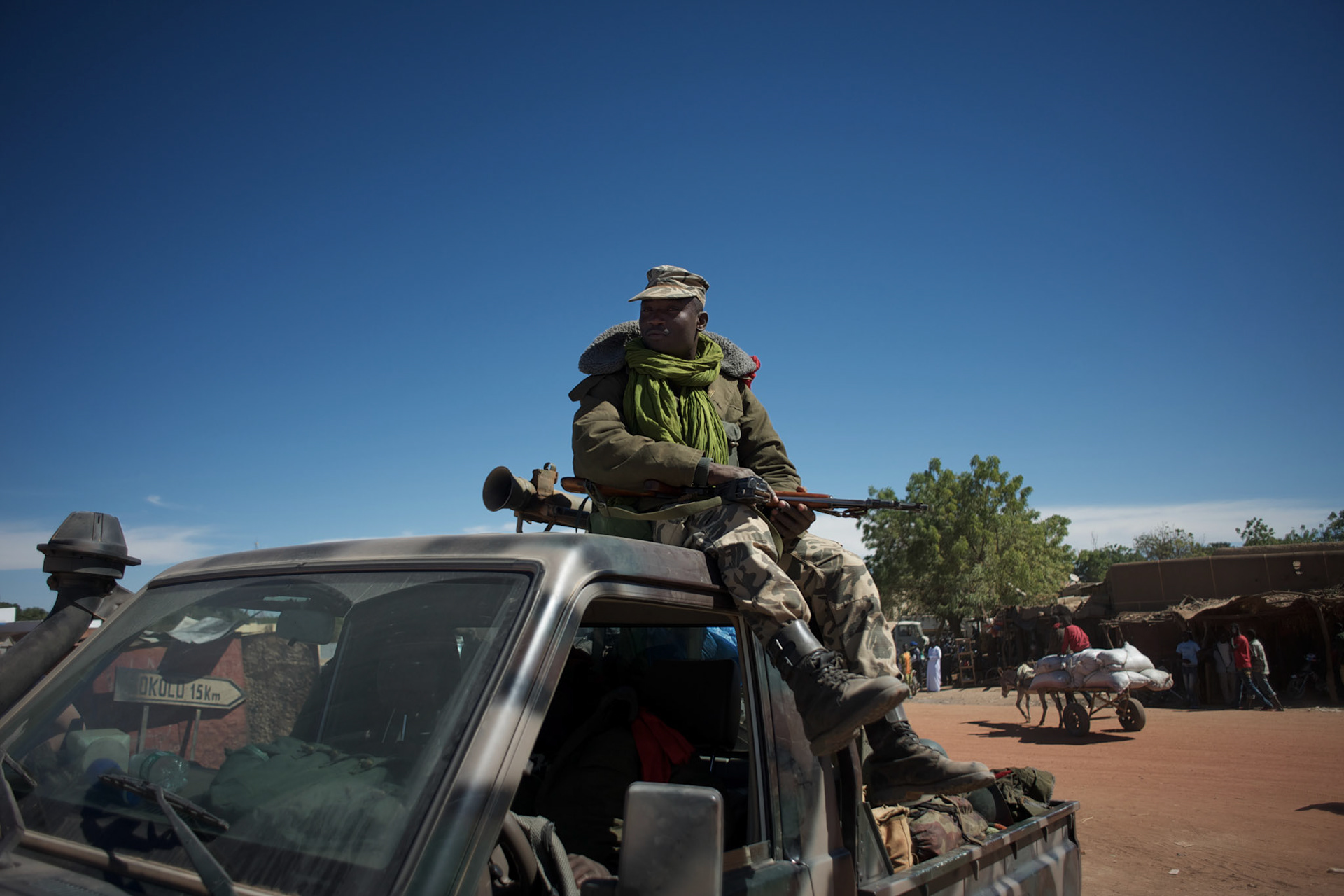 January 21, 2013 - Diabaly, Mali: A Mali army men take guard in Diabaly city centre, a day after the government troops regain control of the city. Diabaly was under islamist militants control since the 14th of January.Several insurgent groups have been fighting a campaign against the Malian government for independence or greater autonomy for northern Mali, an area known as Azawad. The National Movement for the Liberation of Azawad (MNLA), an organisation fighting to make Azawad an independent homeland for the Tuareg people, had taken control of the region by April 2012.The Malian government pledge to the French army to help the national troops to stop the rebellion advance towards the capital Bamako. The french troops started aerial attacks on rebel positions in the centre of the country and deployed several hundred special forces men to counter attack the advance on the ground. (Paulo Nunes dos Santos)