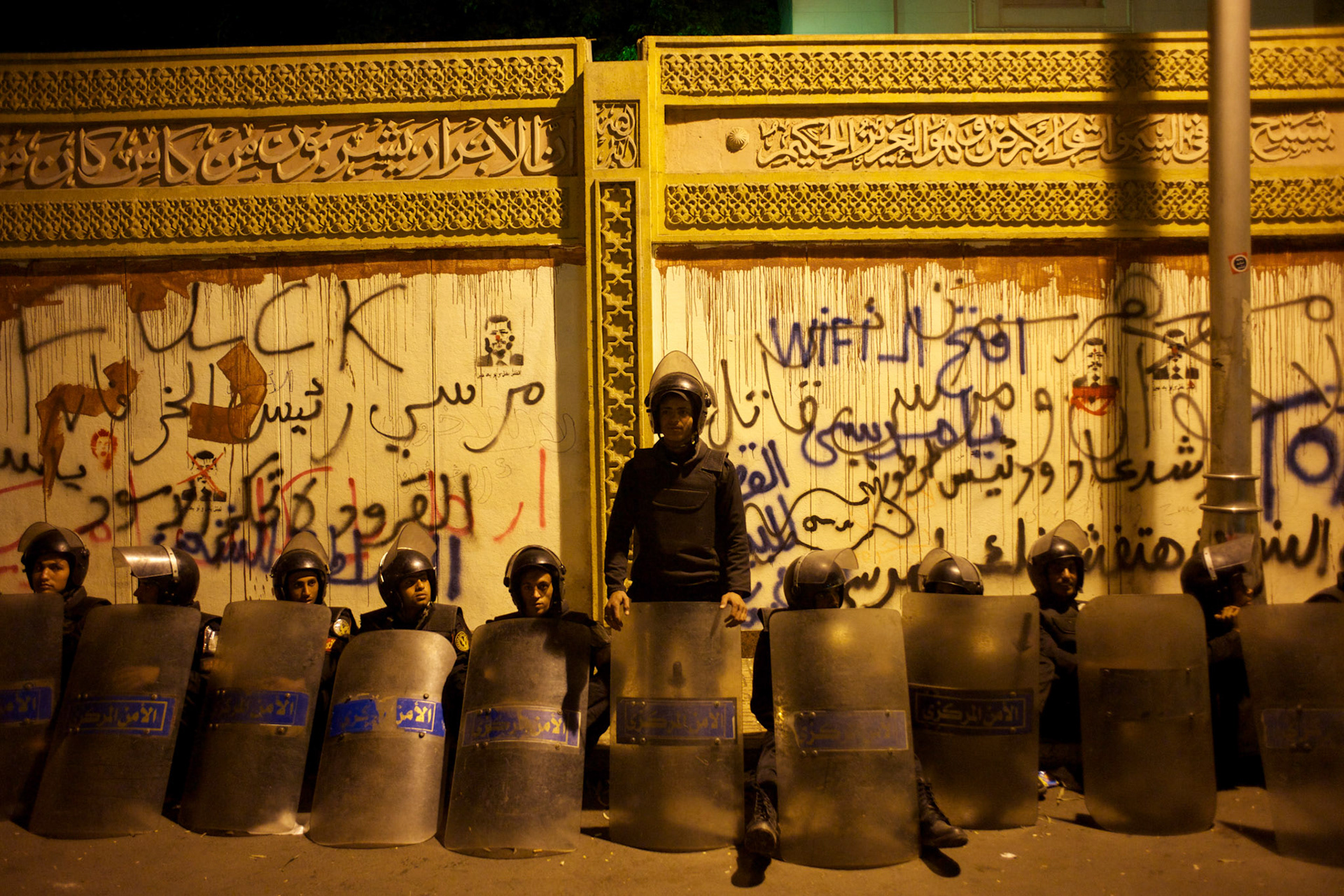 Egyptian National Police takes guard at the presidential palace, in Cairo, where tens of thousands gathered to voice their anger against a planned referendum for a new islamic-based constitution planned by president Mohamed Morsi.