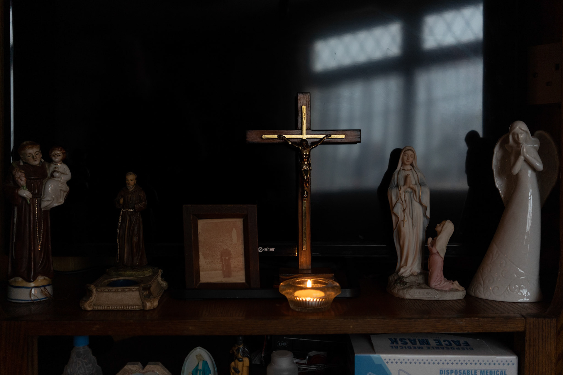 PULLOUGH, IRELAND - NOVEMBER 28, 2021: Religious icons can be seen on display in the house of Joe Gallagher, a Faith Healer and former monk living in Pullough, a small village in County Offaly, Ireland.With touch and prayers, every Sunday Joe gives ‘the cure’ to people looking for treatment for various ailments. As a seventh son, Joe, who is also a former monk, is known for having faith healing powers since young age.Faith healers have been around since antiquity and many Irish believe that certain people have God-given gifts to cure diseases. According to old Irish folklore, the seventh son of a seventh son has special healing powers, however, others get ‘the cure’ passed on to them by a parent or an older relative. CREDIT: Paulo Nunes dos Santos for The New York Times