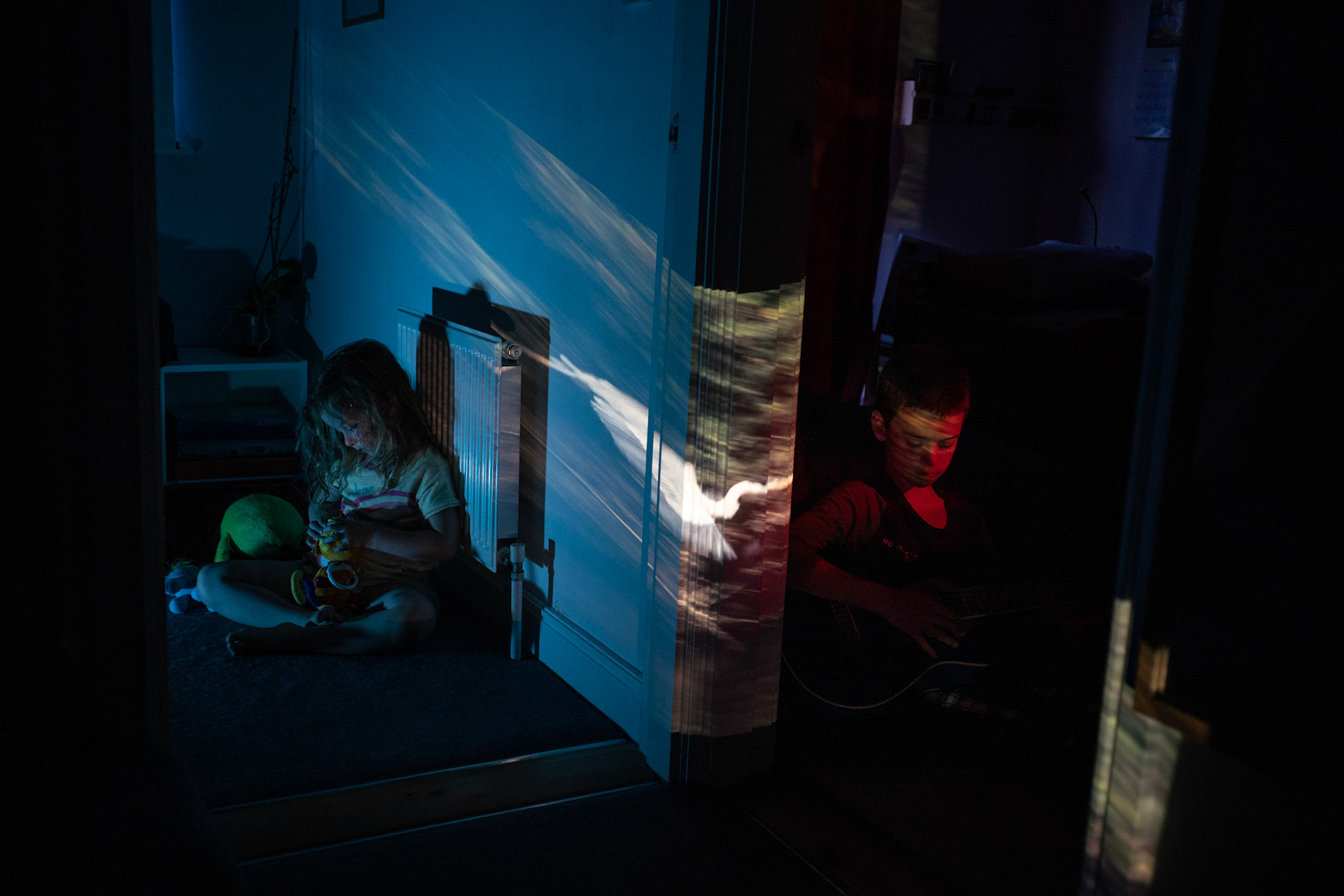 Millie and Oliver with slide of wildlife in the Bolivian Amazon projected onto the office.