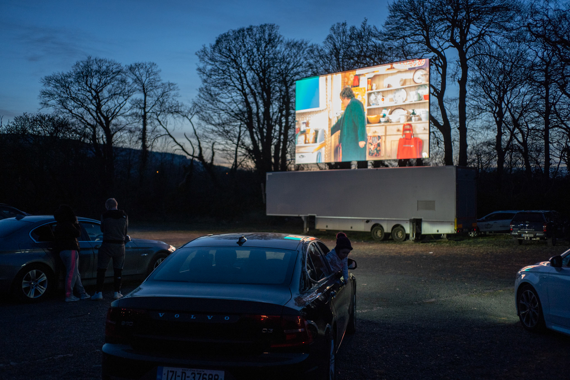 Although a few choose to briefly exit their cars, staff at Retro Drive-In Movies stay vigilant making sure people maintain a safe social distance. Dublin, Ireland - March 24, 2020.