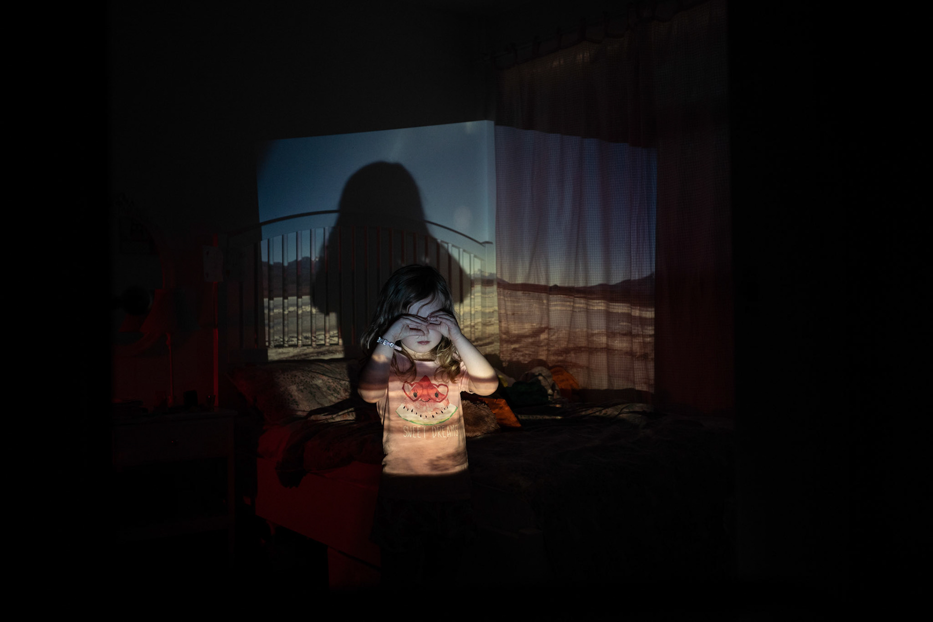 Millie with slide of sulfur lake in Salar de Uyuni project onto her bedroom.