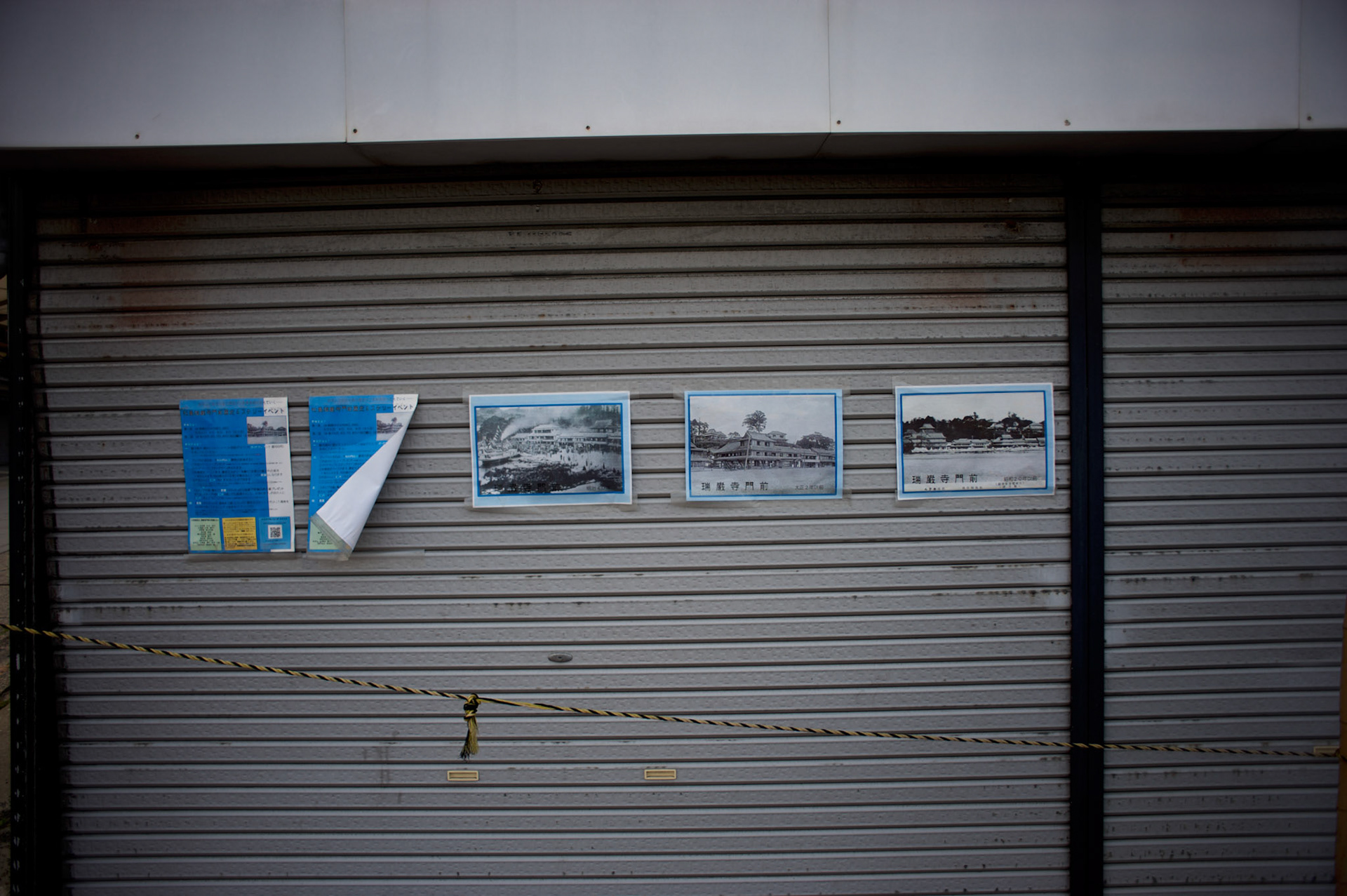 In Matsushima, posters with images of destruction can be seen on display in the doors of a shop closed down due to the damaged cause by the 2011's tsunami that struck Japan's coastal line, causing thousands of deaths.