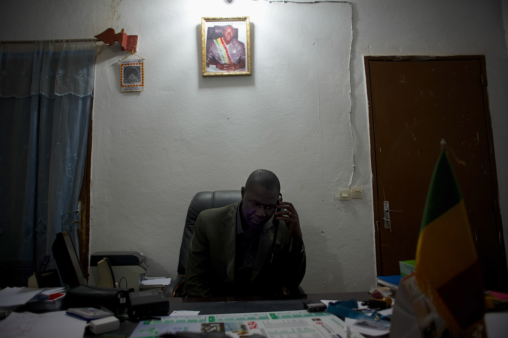 January 19, 2013 - Niono, Mali: Moriba Coulibaly, the Major of Niono village, receives a call from people sieged in the neighbouring cry of Diabaly. Niono is the last government controlled location before Diabaly, a city under islamist militants control since the 14th of January. In the backSeveral insurgent groups have been fighting a campaign against the Malian government for independence or greater autonomy for northern Mali, an area known as Azawad. The National Movement for the Liberation of Azawad (MNLA), an organisation fighting to make Azawad an independent homeland for the Tuareg people, had taken control of the region by April 2012.The Malian government pledge to the French army to help the national troops to stop the rebellion advance towards the capital Bamako. The french troops started aerial attacks on rebel positions in the centre of the country and deployed several hundred special forces men to counter attack the advance on the ground. (Paulo Nunes dos Santos)