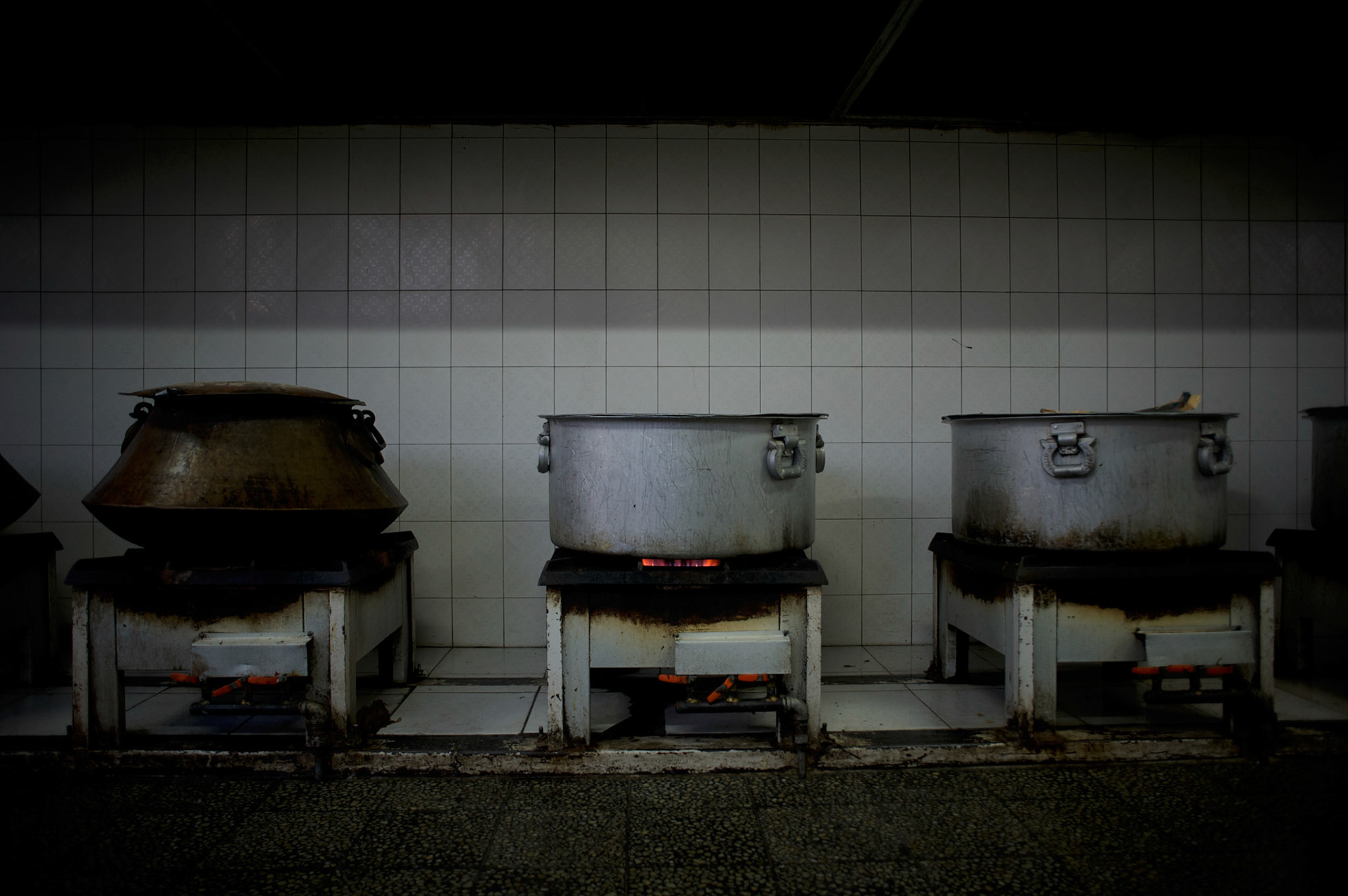 Hot pots containing milk for breakfast are seen at the kitchen of the Afghan Nacional Police Academy in Kabul.