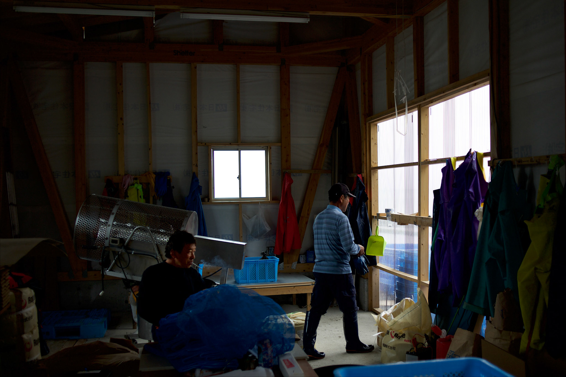 Fishermen of Togura at a storage shed in the local port after collecting ropes used to grow sea weed. Togura, a small fishing village in Minami Sanriku, was vastly destroyed by the 2011 tsunami that hit the northeast coast of Japan. Thousands died and hundreds of families lost their houses, business and boats. The recovering community works now in a cooperative system where the few remaining boats spared by the tsunami are shared by all.
