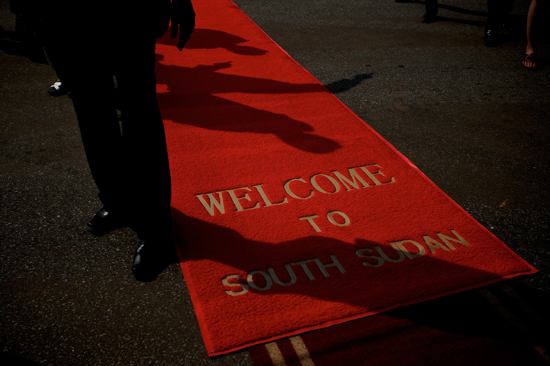 A security personal takes guard of the red carpet laid to receive international delegates attending the official ceremony marking South Sudan as an independent nation.