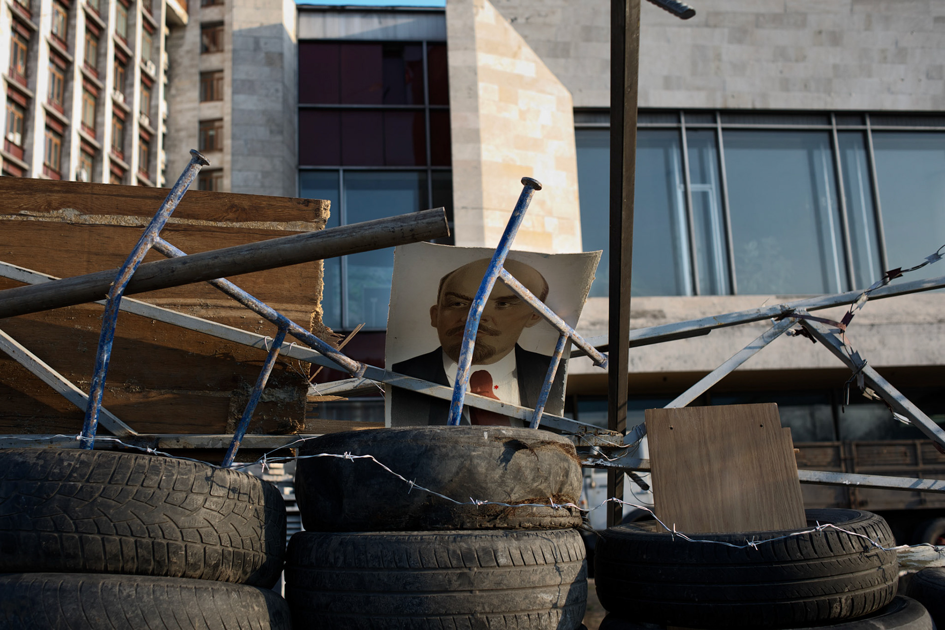 A portrait of Lenin sits atop a barricade surrounding a besieged government building in Donetsk.