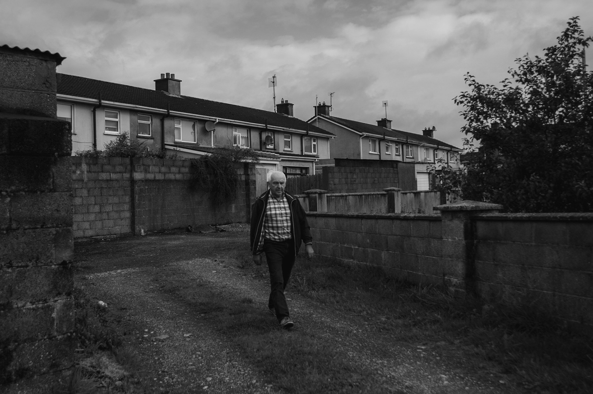 TUAM, IRELAND - AUGUST 24, 2017: PJ Haverty, a former resident of the St. Mary’s Mother and Baby Home in Tuam, walks towards the grave site where local historian Catherine Corless believes 796 children, most of them infants, were interred. Haverty is now an active campaigner in the efforts to have recognised the grim legacy of the institution which housed unmarried mothers and their children from the 1920s to 1961. CREDIT: Paulo Nunes dos Santos for The New York Times