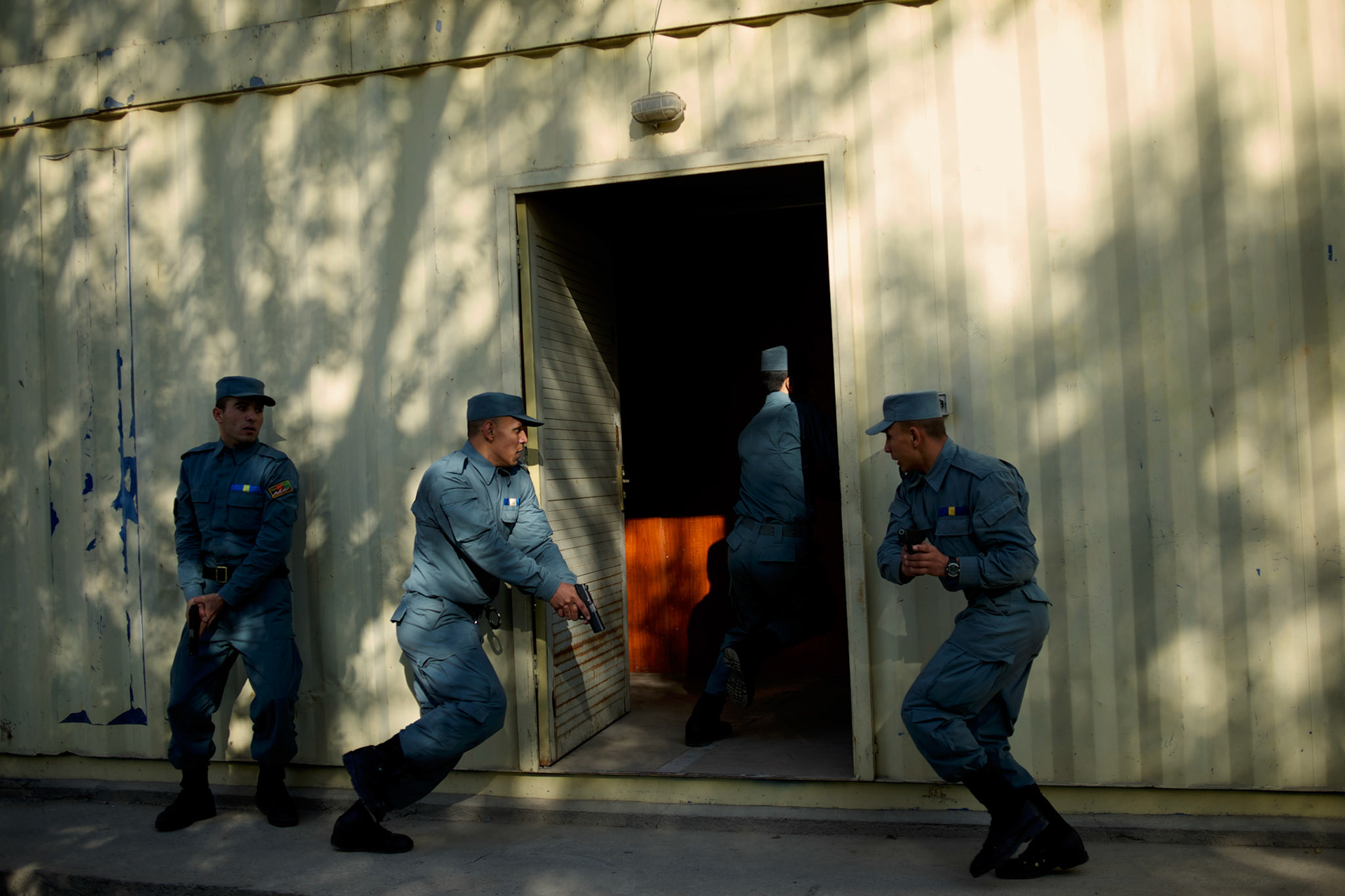 Afghan National Police (ANP) cadets simulate a raid to a Taliban house during combat exercises at the Afghan Nacional Police Academy in Kabul.