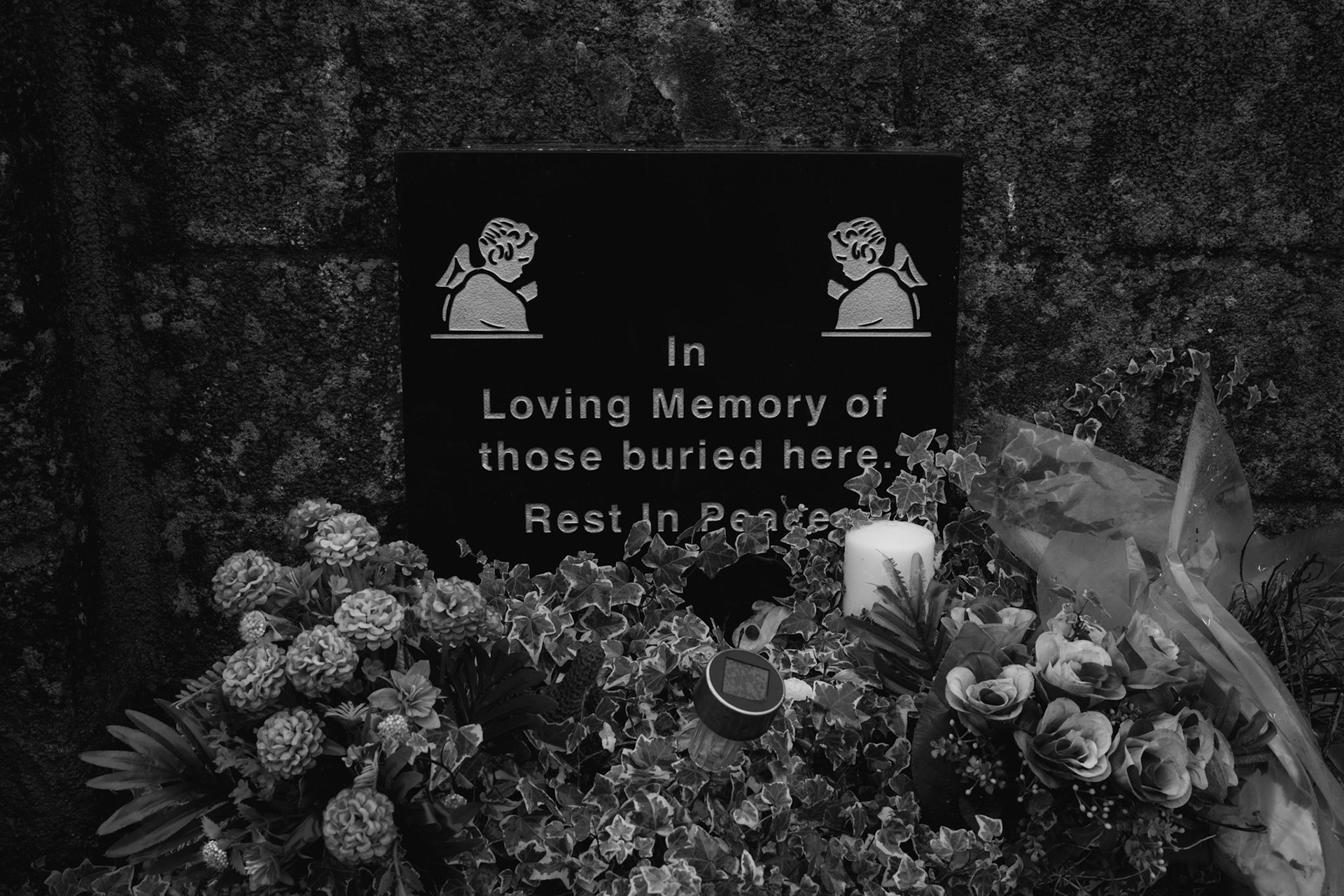 TUAM, IRELAND - SEPTEMBER 27, 2022: A plaque in honour of hundreds of infant bodies buried on the grounds of the former St. Mary’s Mother and Baby Home, can be seen at the entrance to the site of the former institution in Tuam, Ireland, on September 27, 2022.  In 2014, local historian Catherine Corless, went public with information concerning the deaths of 798 children at St. Mary’s Mother and Baby Home, a maternity home for unmarried mothers and their children run by the Bon Secours order in Tuam. Corless' research led her to conclude that almost all had been buried in an unmarked and unregistered site at the Home. Subsequent excavations carried out by an Irish government appointed Commission, found a significant quantity of human remains in a vault with twenty chambers, believed to be part of an old septic tank from the period the site was use as a workhouse. CREDIT: Paulo Nunes dos Santos for The New York Times