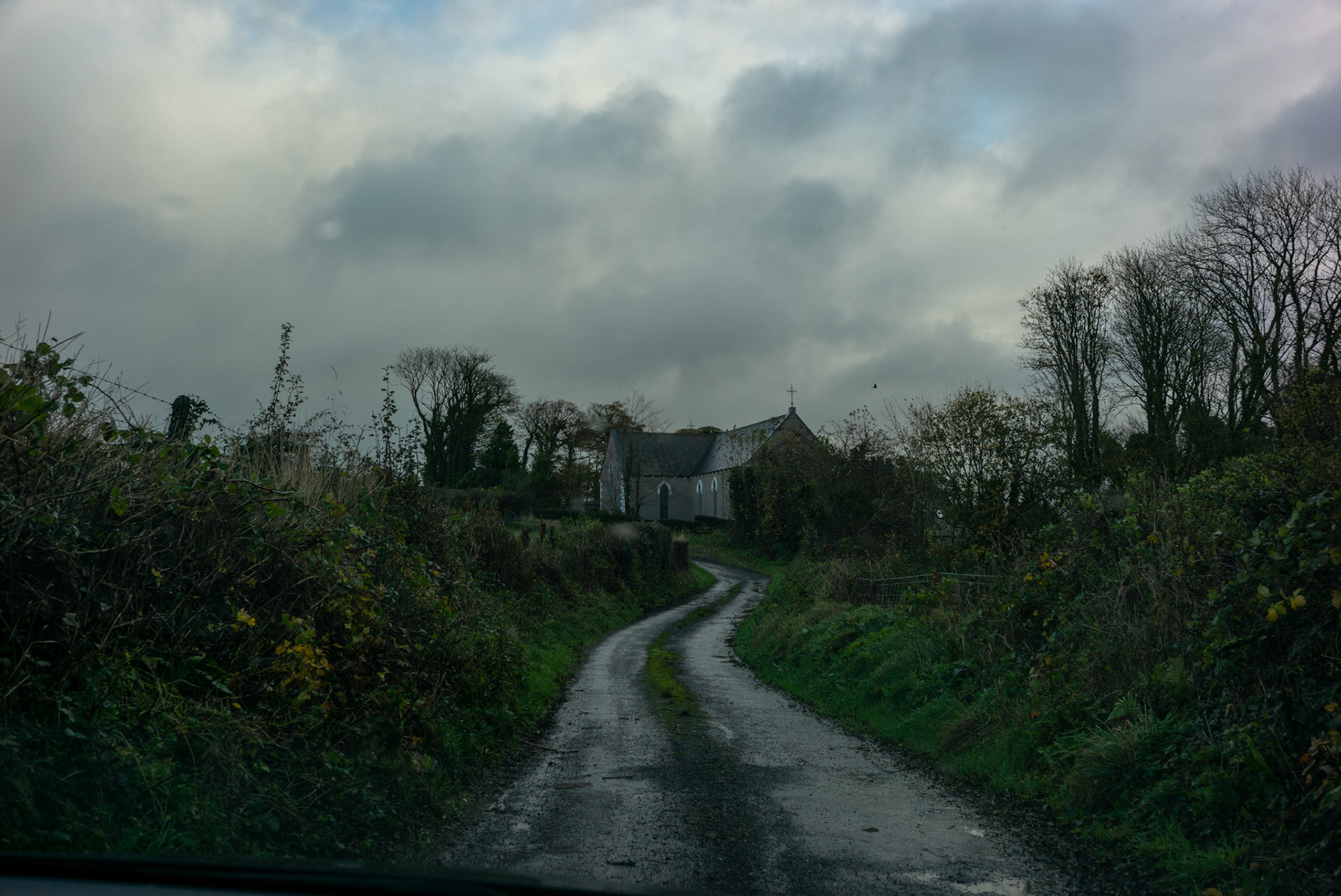 BALLINA, IRELAND - NOVEMBER 12, 2021: View of Rathduff Church as seen from the driveway to Faith Healer’s Andrew Keane family home in Cloghans, a small location outside Ballina in County Mayo, Ireland. A construction worker by trade, Mr. Keane is just one of hundreds dotted across the country who are healers or have “the cure” as it’s commonly known here. Some, like him, are seventh sons, believed for generations to be healers, but others are keepers of customs passed down through their families that range from rituals, prayers and charms to herbal tinctures that are offered up as remedies for everything from burns to sprains to shingles and other ailments. CREDIT: Paulo Nunes dos Santos for The New York Times