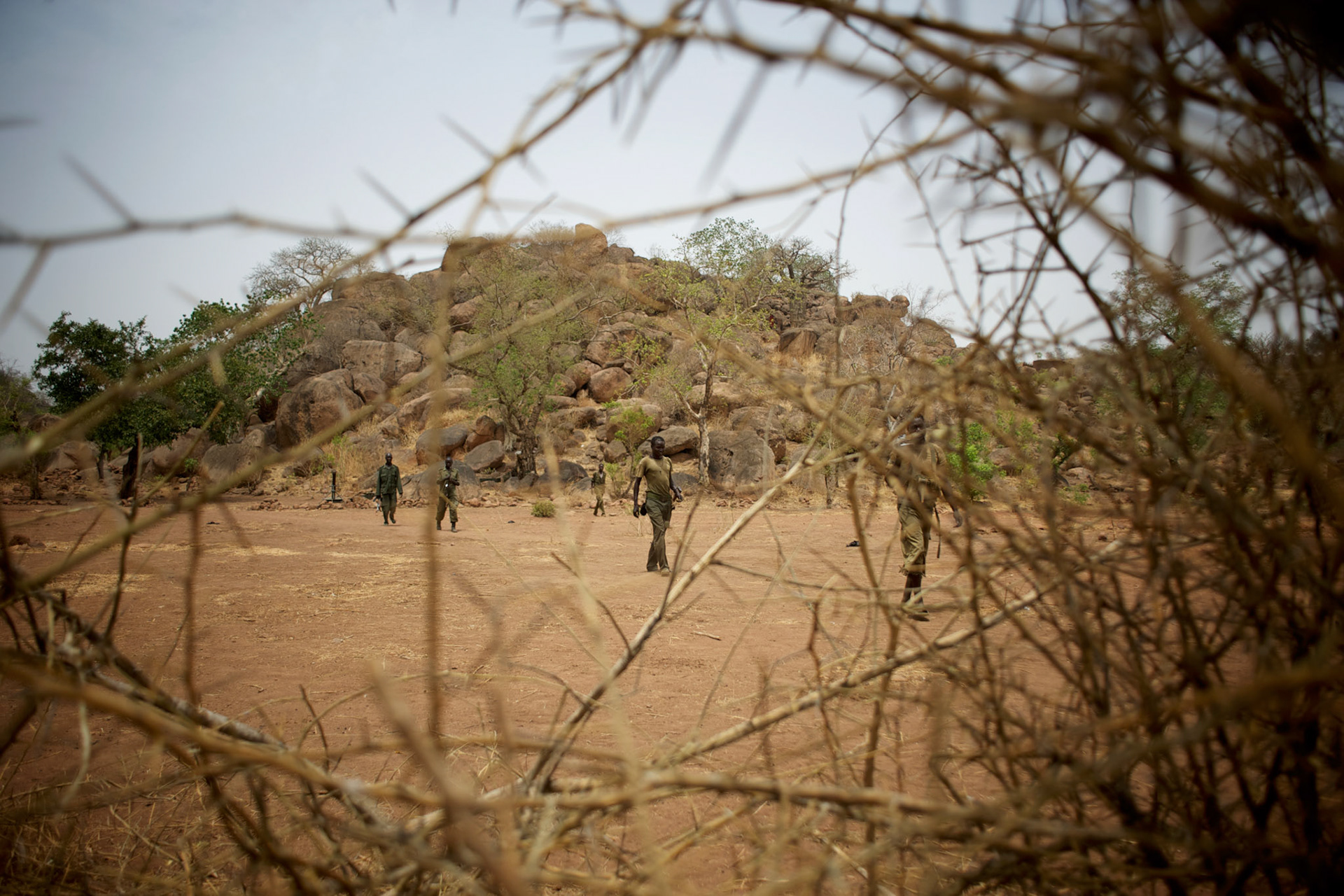 A field commander of Sudan People's Liberation Movement (SPLA-N) walks by in Jebel Kwo military base near Tess village in the rebel-held territory of the Nuba Mountains in South Kordofan. SPLA-North, an historical ally of South Sudan's former rebel forces SPLA, has been fighting the Sudanese Army Forces (SAF) over the right to autonomy and of the end of persecution of Nuba people by the regime of President Bashir.