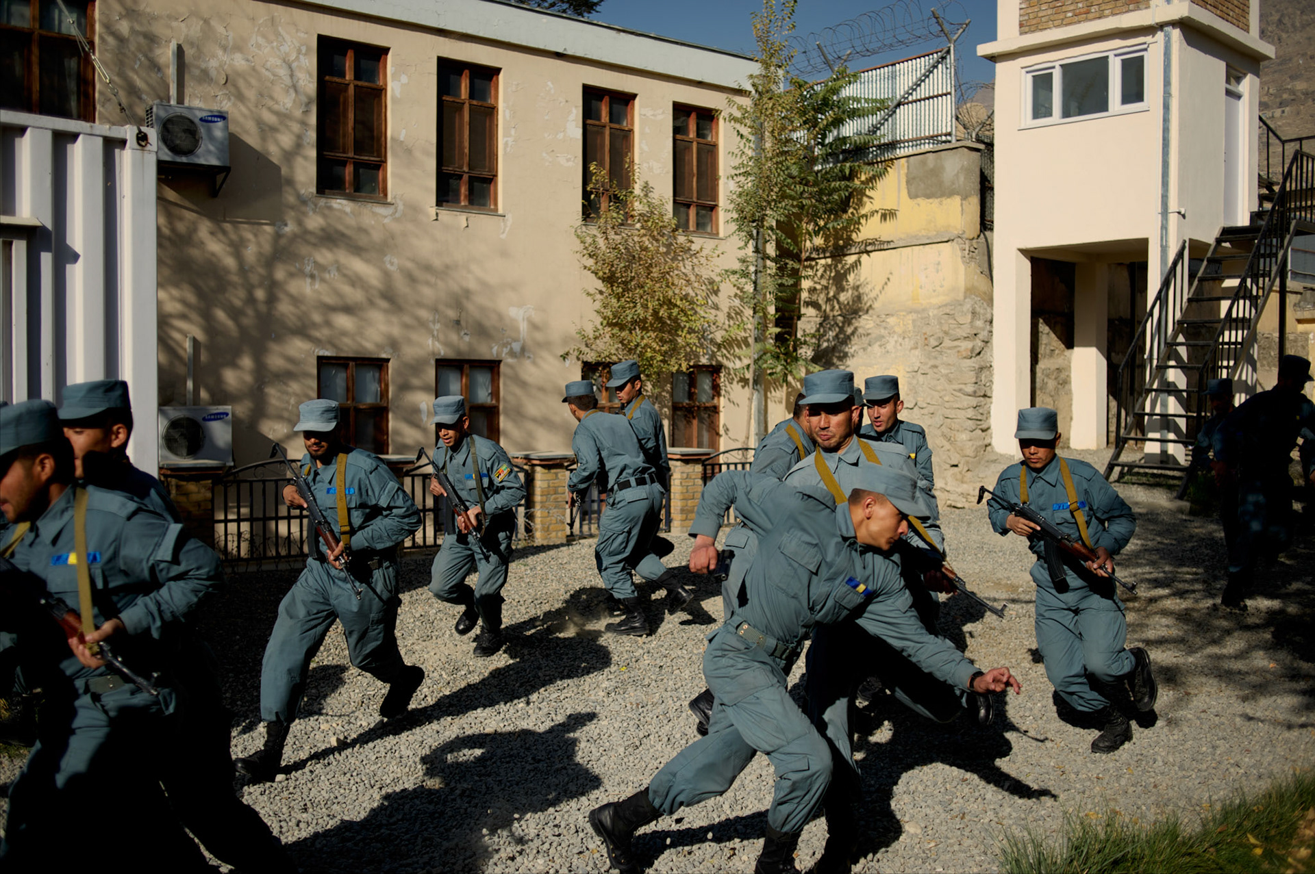 Afghan National Police (ANP) cadets react to a simulated attack by the Taliban during combat exercises at the ANP Academy in Kabul, Afghanistan.