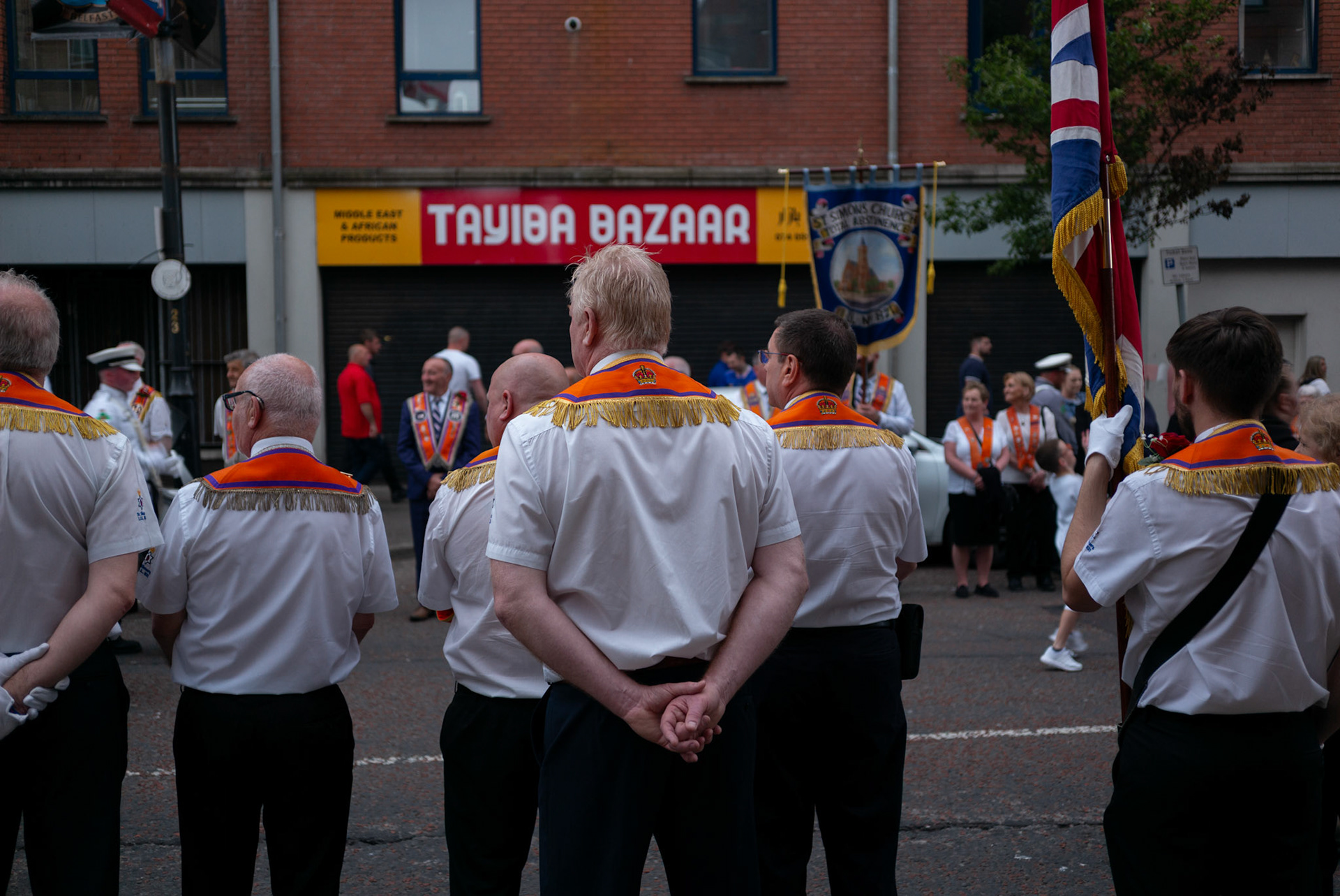 Orangemen line up to watch loyalist marching flute bands parade through South Belfast on July 2, 2021, to mark the anniversary of the Battle of the Somme.