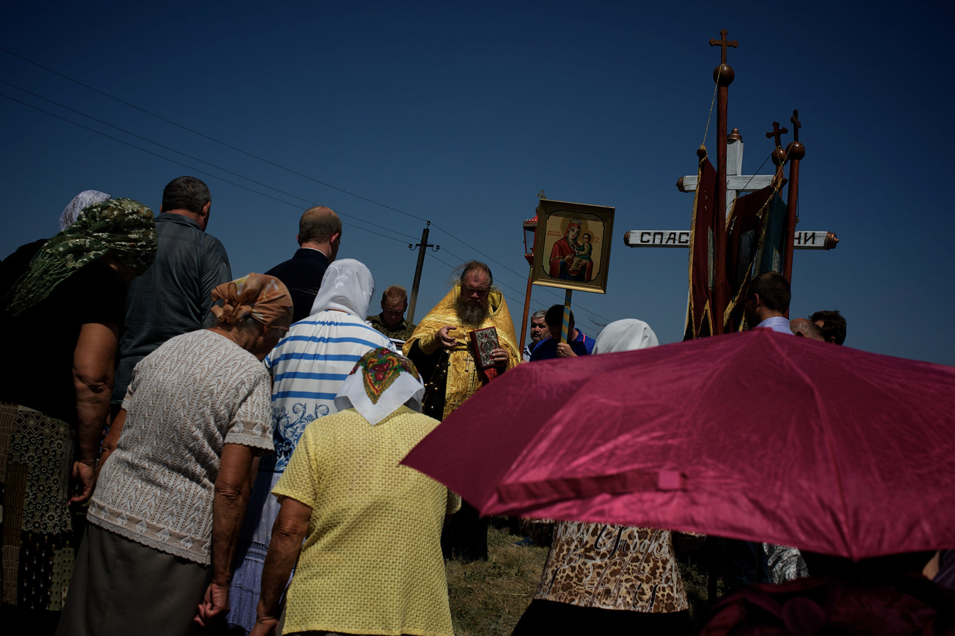 A religious ceremony taking place at the Malaysia Airlines flight MH17 crash site in Grabovo.
