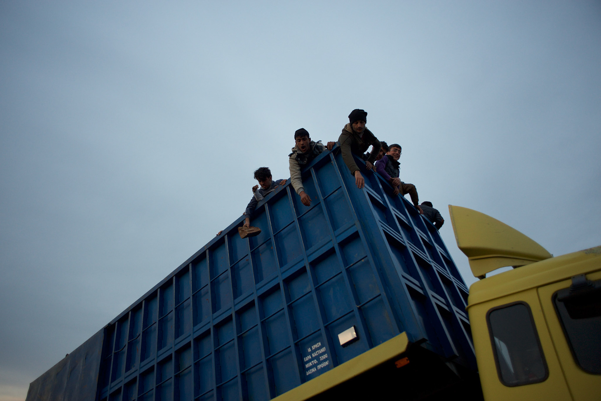 Migrants and refugees unload firewood donated by locals at the Greek-Macedonian border in Idomeni, Greece. Around 13,000 migrants and refugees, mostly from the Middle East and African nations, are believe to be stranded here awaiting a chance to proceed their journey towards Germany and other northern European countries.