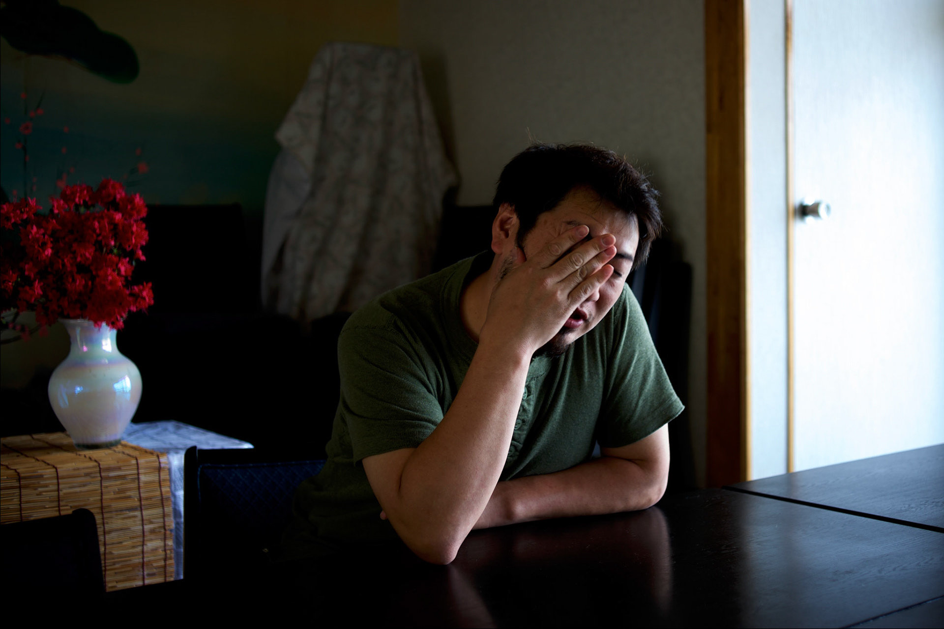 A survivor from the devastating earthquake and tsunami that hit the east coast of Japan in 2011, reacts as he recounts the moment he saw his neighbours been dragged to see by the waves in Togura.
