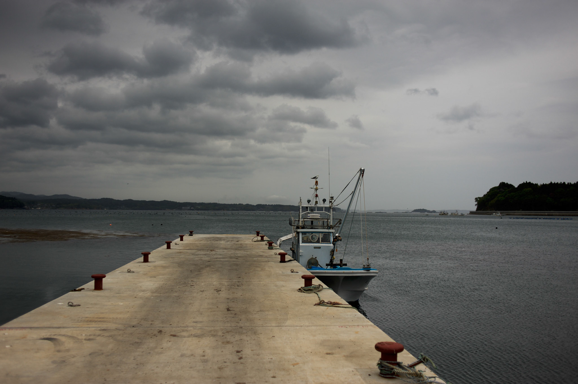 View of a docked fishing boat in a pier in Togura, Miyagi prefecture. Since the 2011's tsunami that struck over the coastal areas of Japan, the fishing community of Togura, devastated by the natural disaster, formed a cooperative where all the families work together using the only two remaining boats in the whole village.