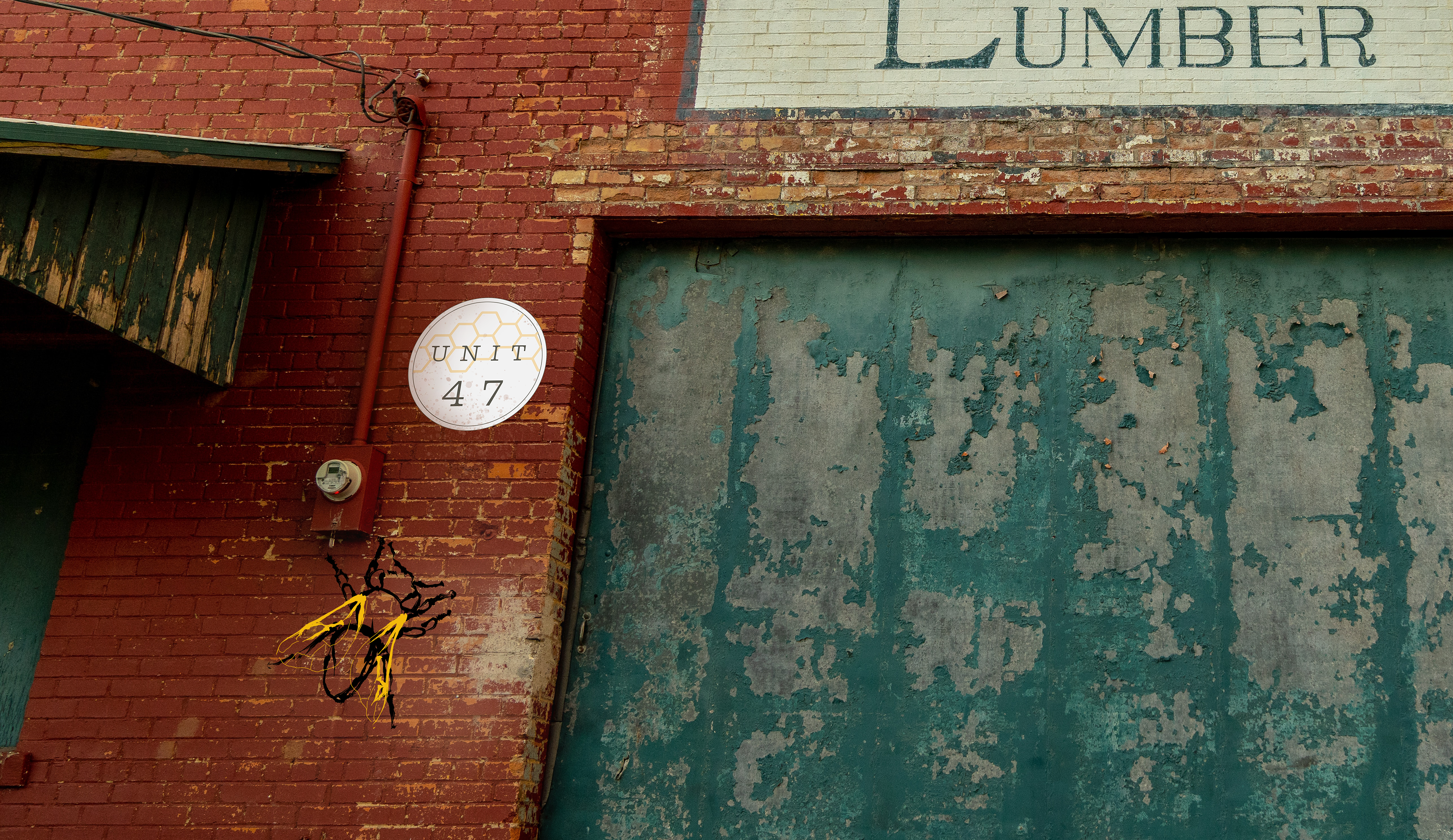 Picture of the Ohio Valley Storage unit marker 47, and a decal with the illustrated honeybee on the side of a storage unit.