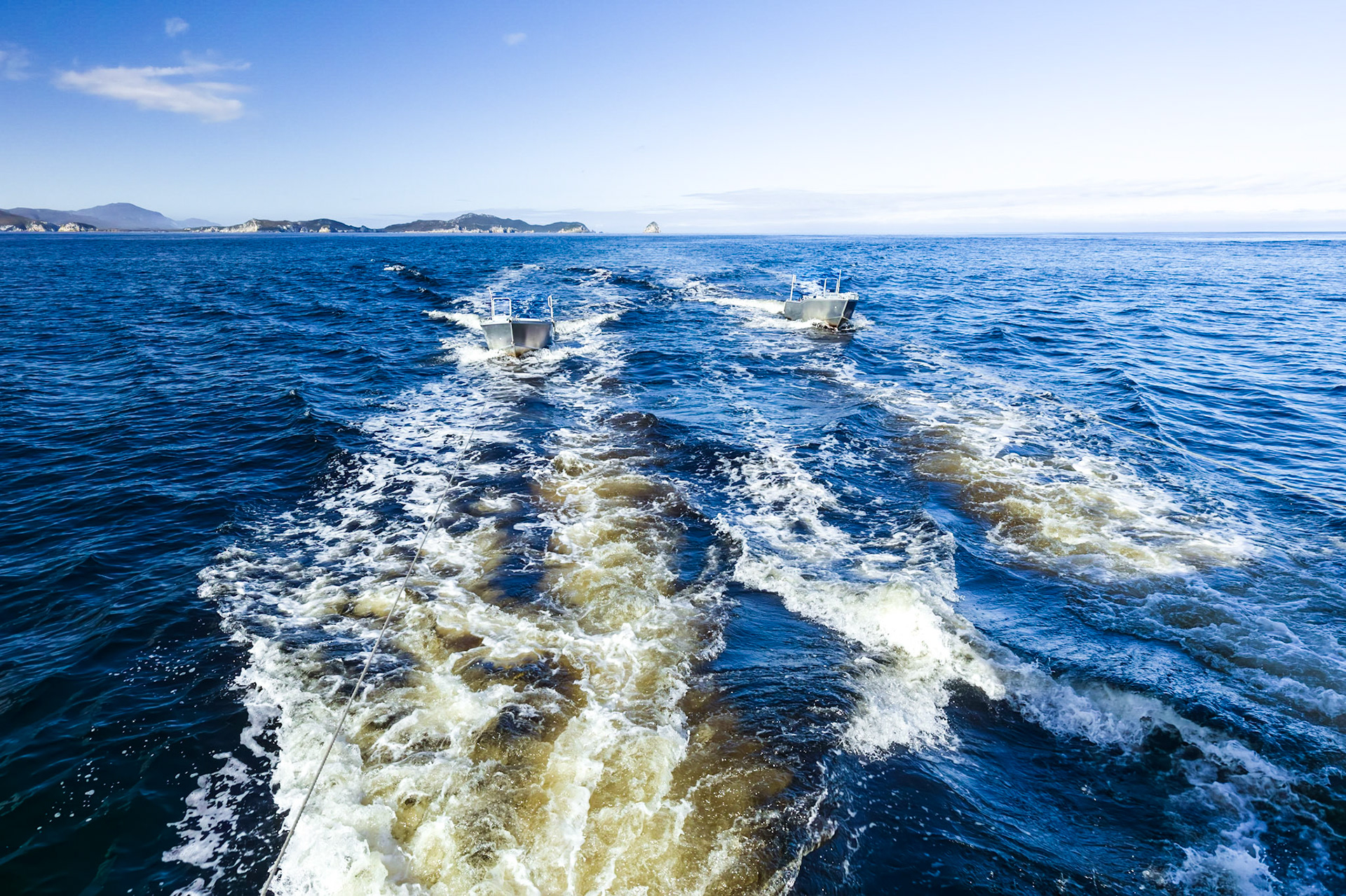 Odalisque moving on to the next anchorage; towing the pair of tender boats.