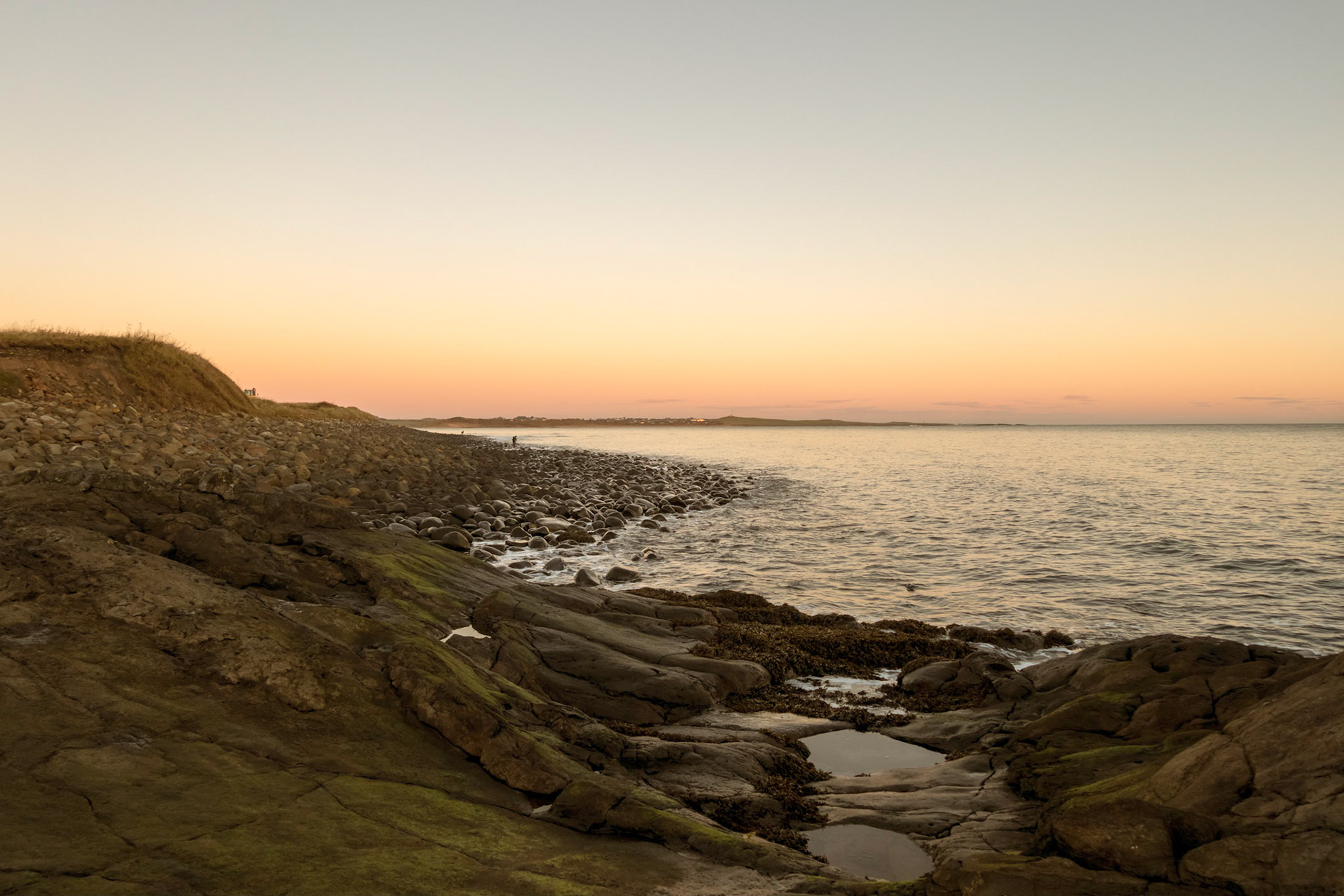 Embleton Bay at sunrise, to the North from Dunstanburgh Castle