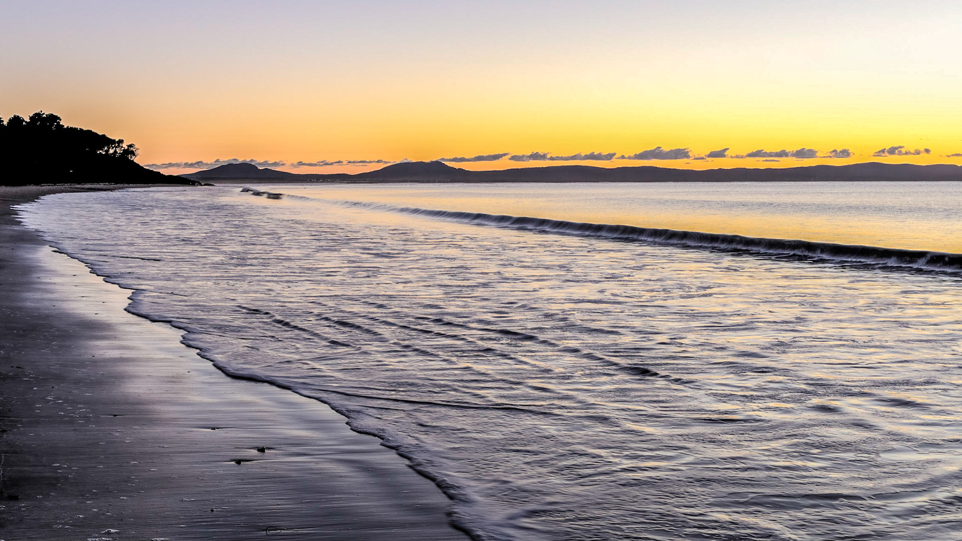 Glow of the approaching sunrise. Watching the dawn over Freycinet from Swansea Beach