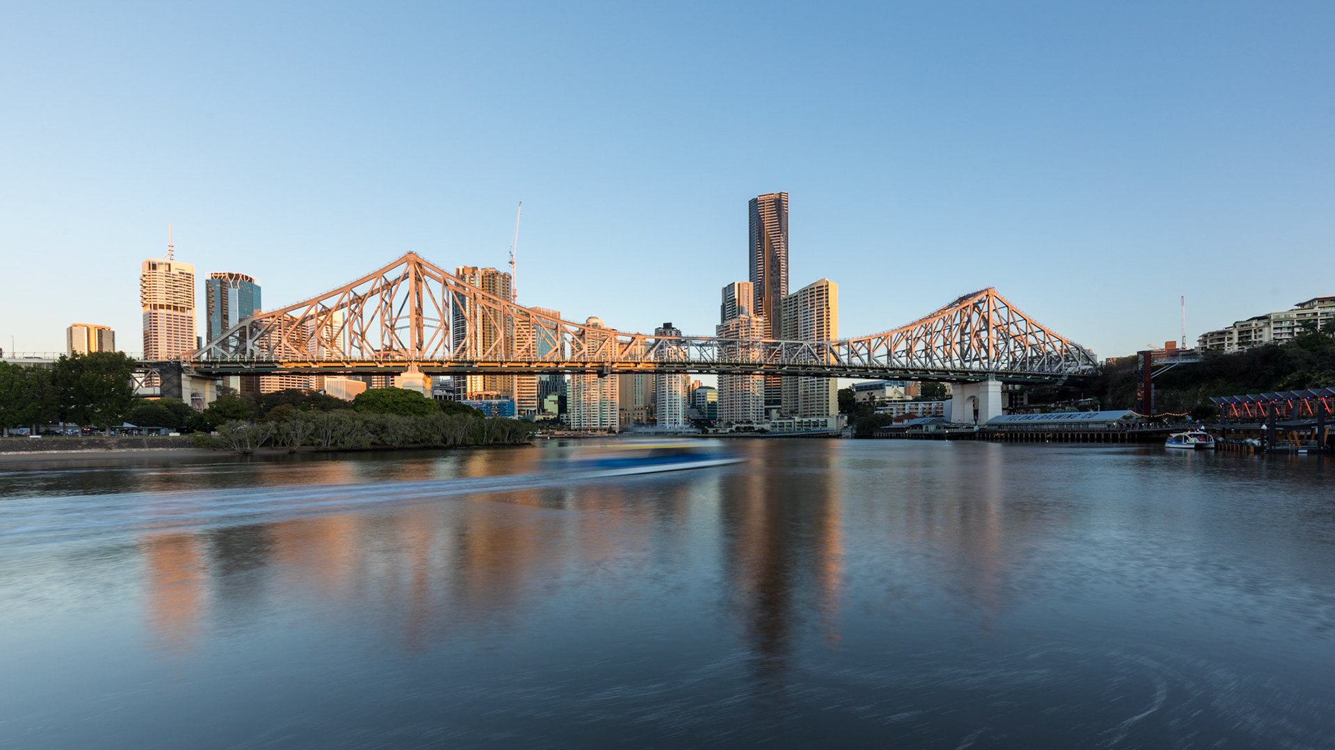 View at sunrise (06:38) from the Brisabne River Walk. Rivercat Ferry passing