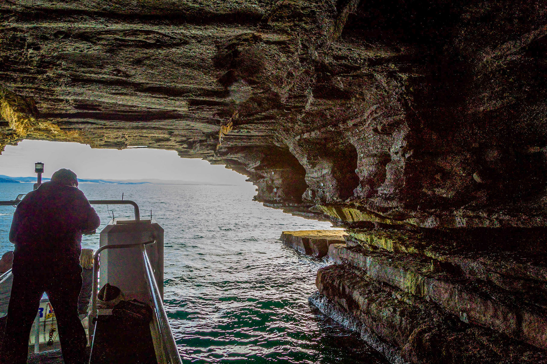 At the entrance to a cave created by the sea into the base of the cliff. Maria Island