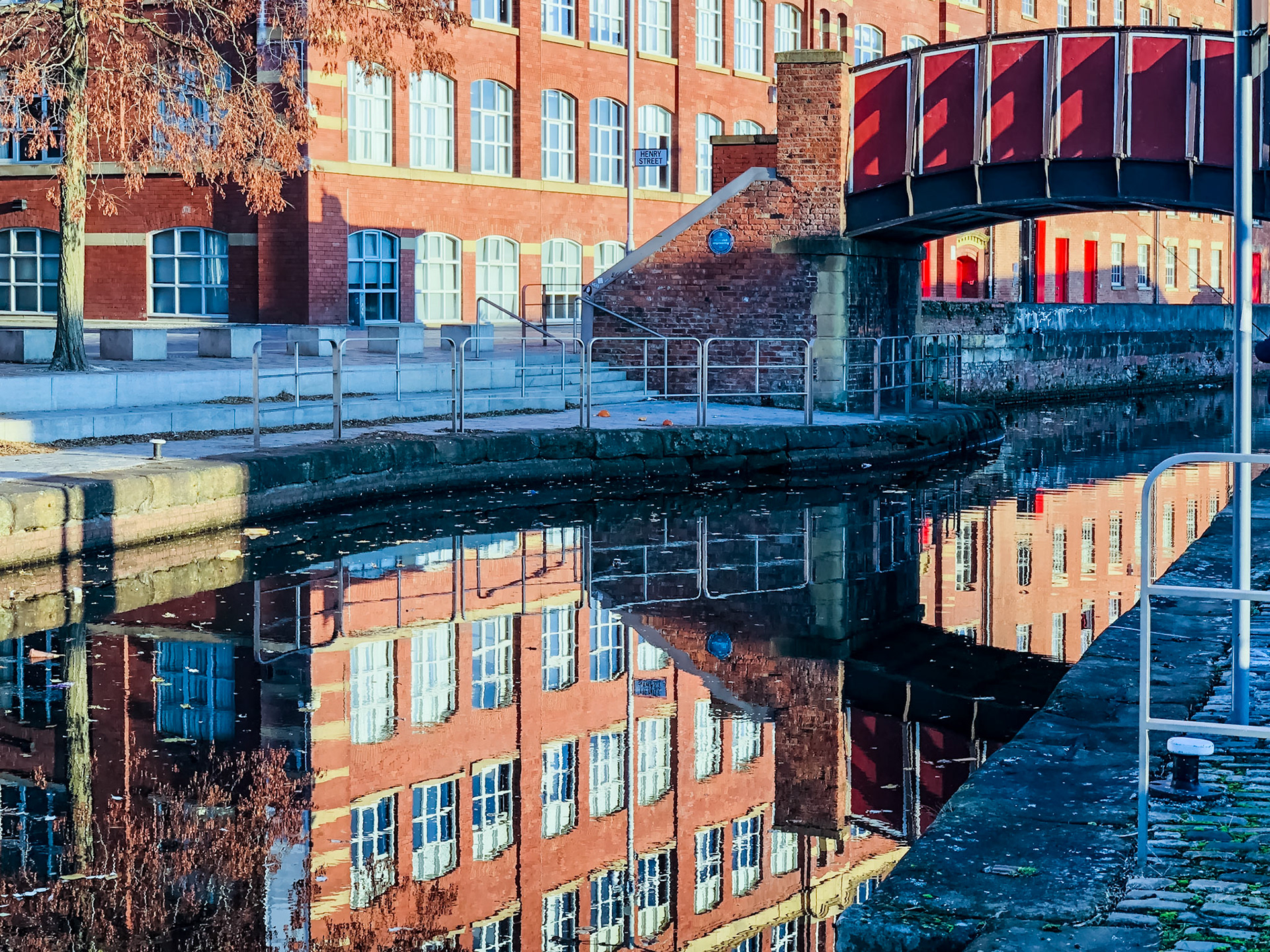 Royal Mill in Canal Reflections. Royal Mill, Erected 1797 and rebuilt 1912 and proudly proclaims to have been visited by the King and Queen on Nov 19th 1942.