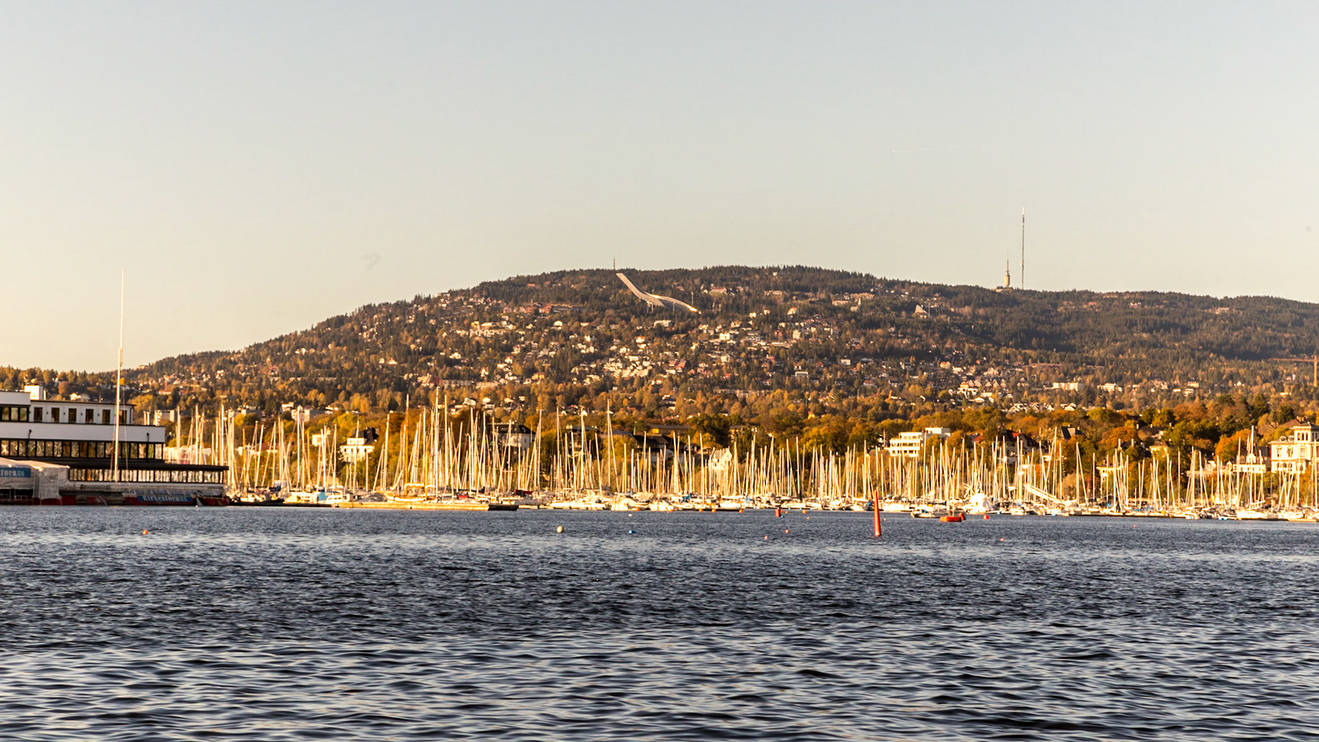 Royal Norwegian Sailing Club. Ski jump on the hill in the background.