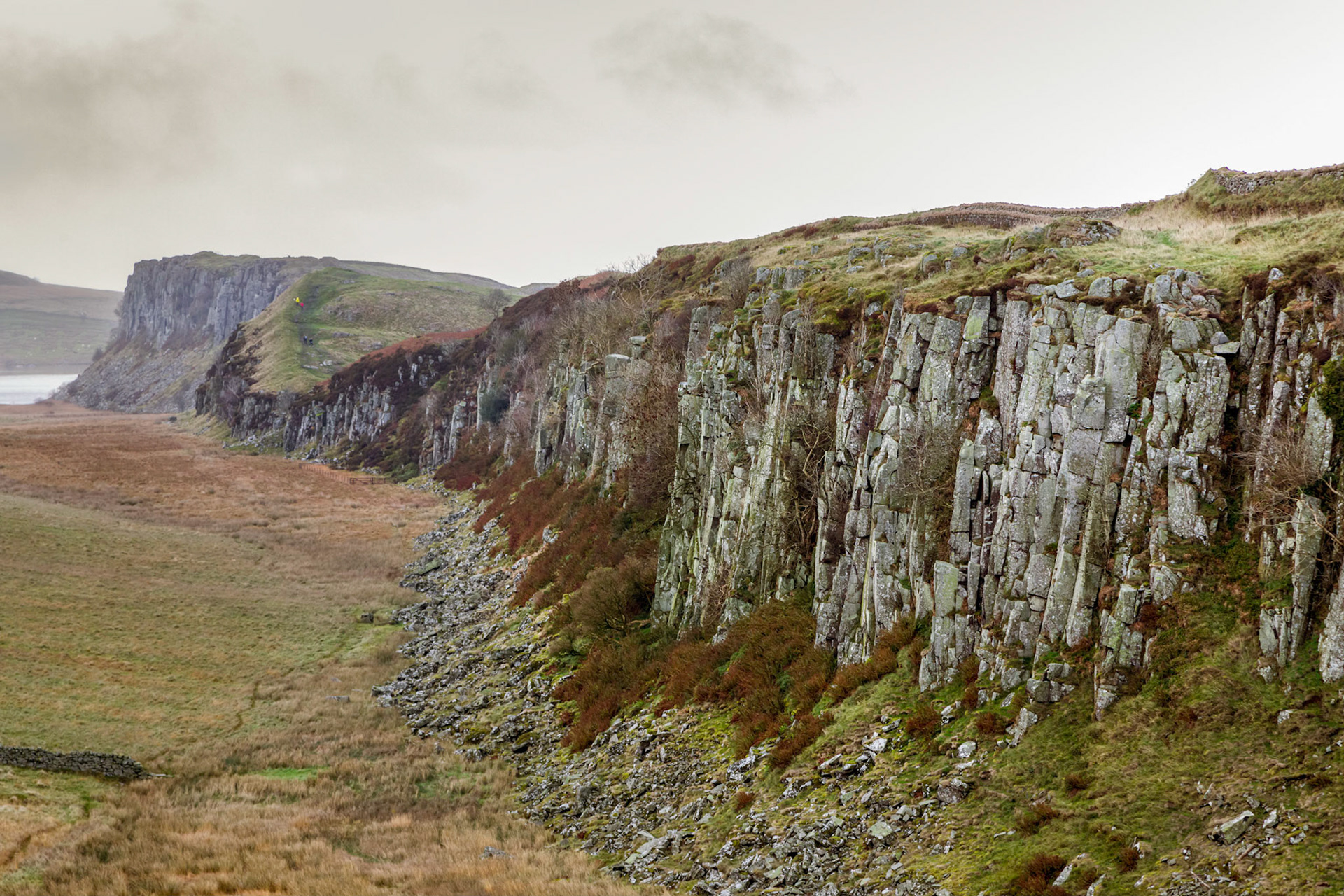 At Steel Rigg Hadrian's Wall running along the top of the escarpment. Northumberland National Park.
