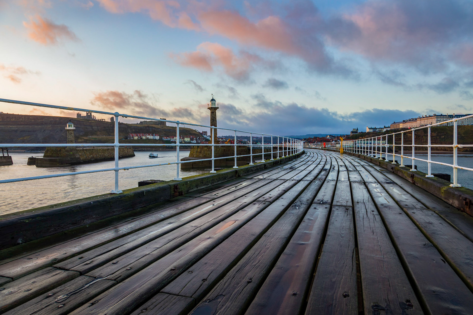 Sunrise on the promenade deck above the Whitby Harbour breakwater.